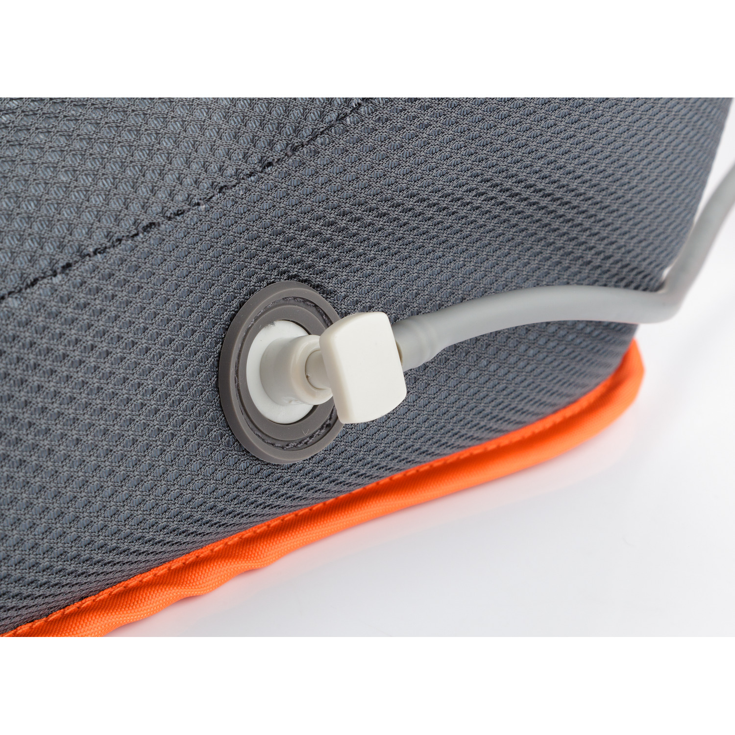Close-up shot of a charging port with a white cable.