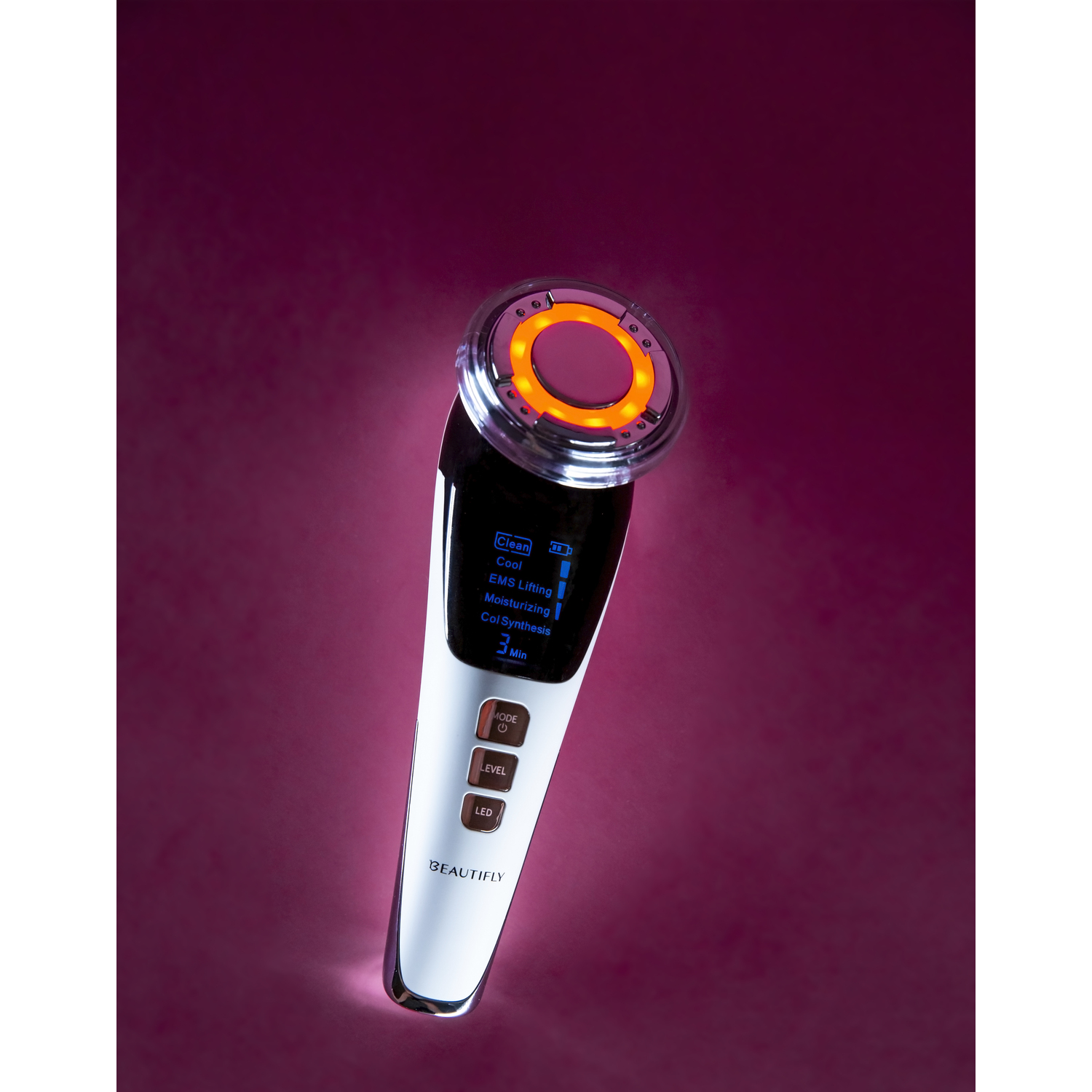 White and black facial device. Orange light on top. Display. Isolated on a red background.