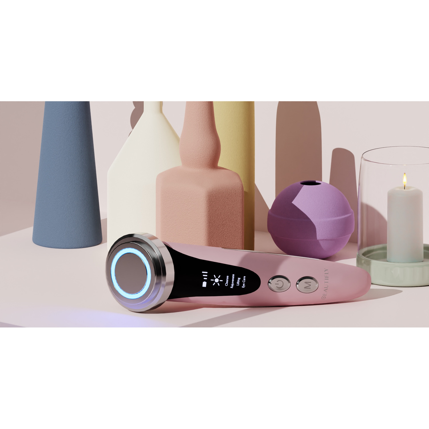 Pink beauty device on a table with vases and a lit candle.