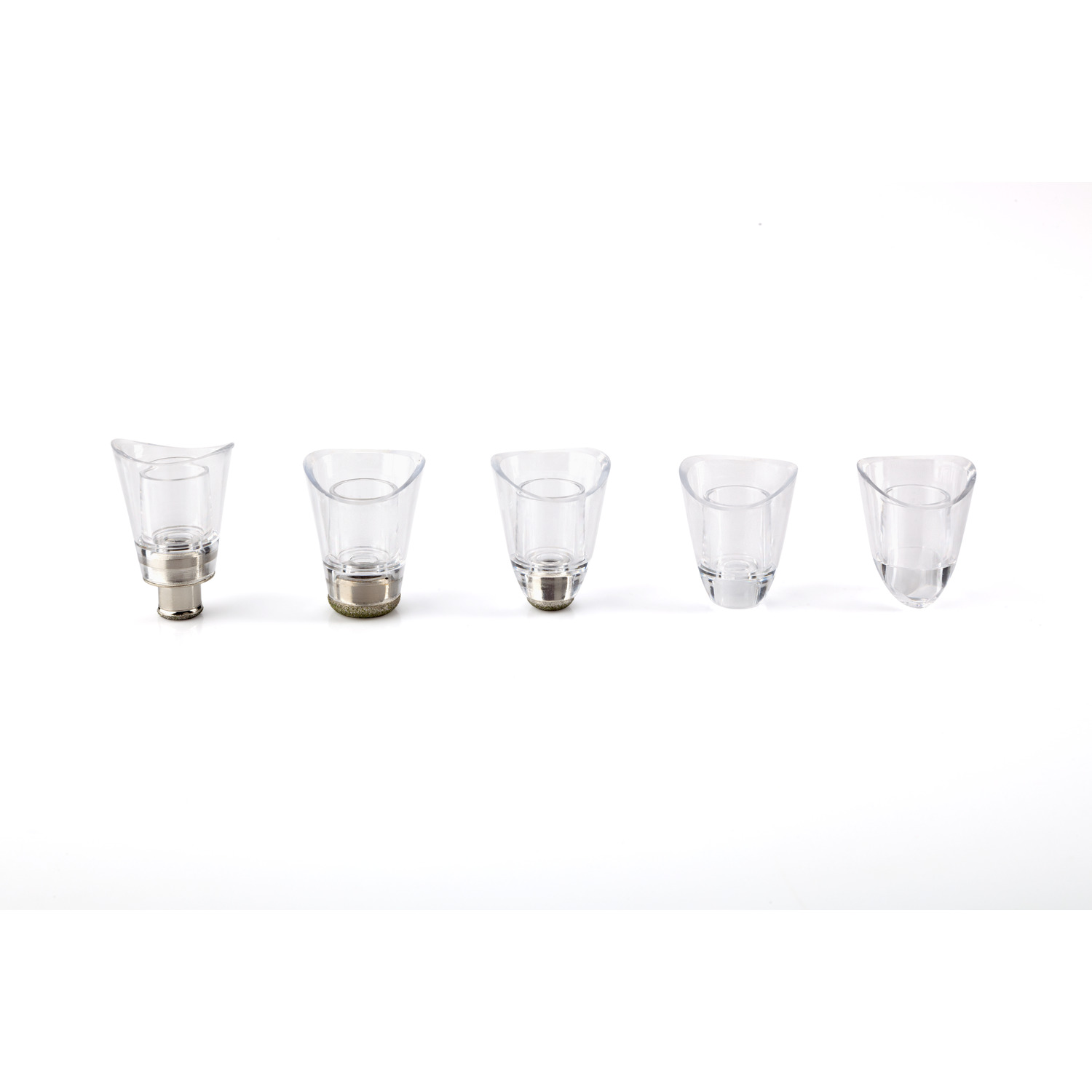 Five transparent cosmetic device tips on a white surface. 
