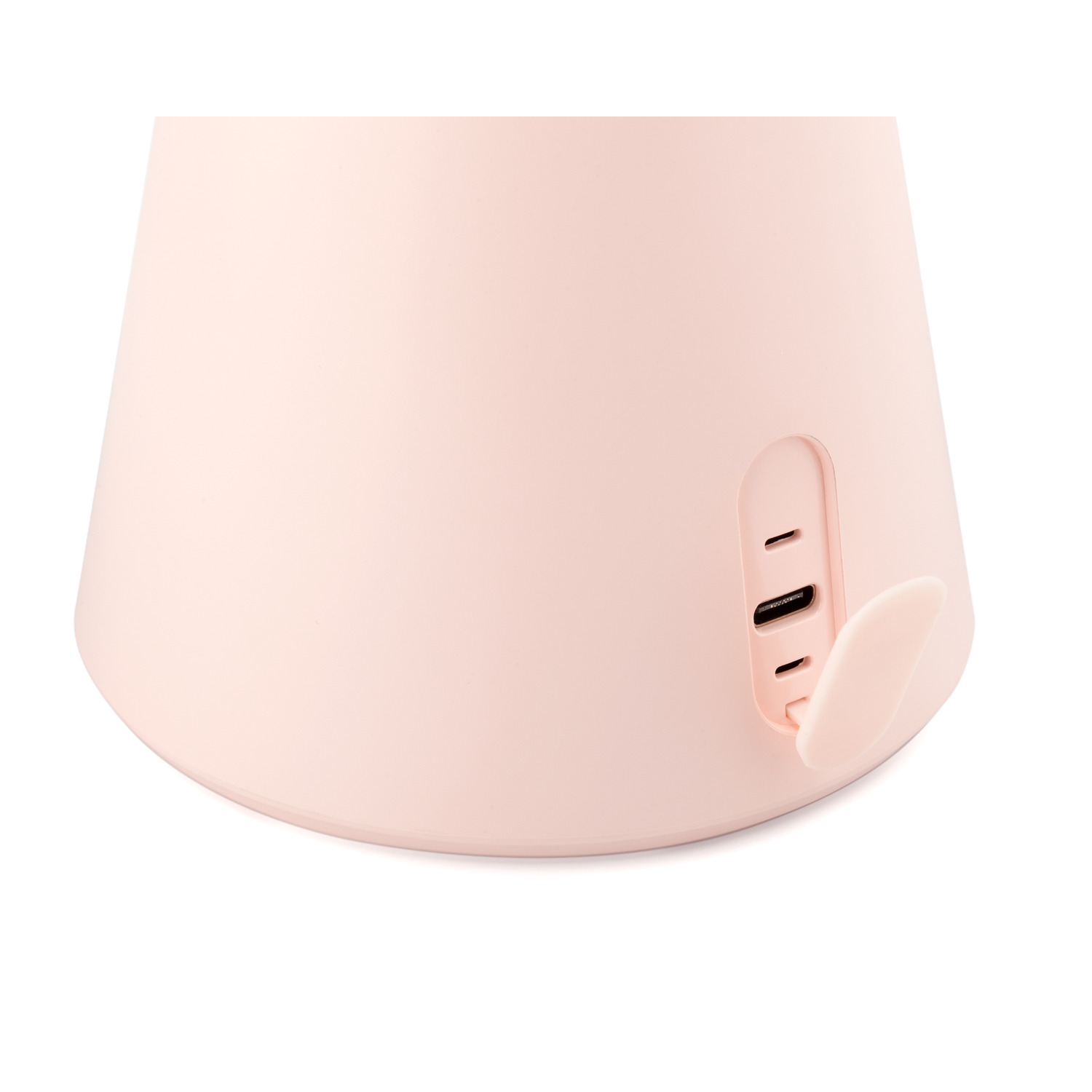 Close-up of a pink makeup mirror base with a charging port and cover.