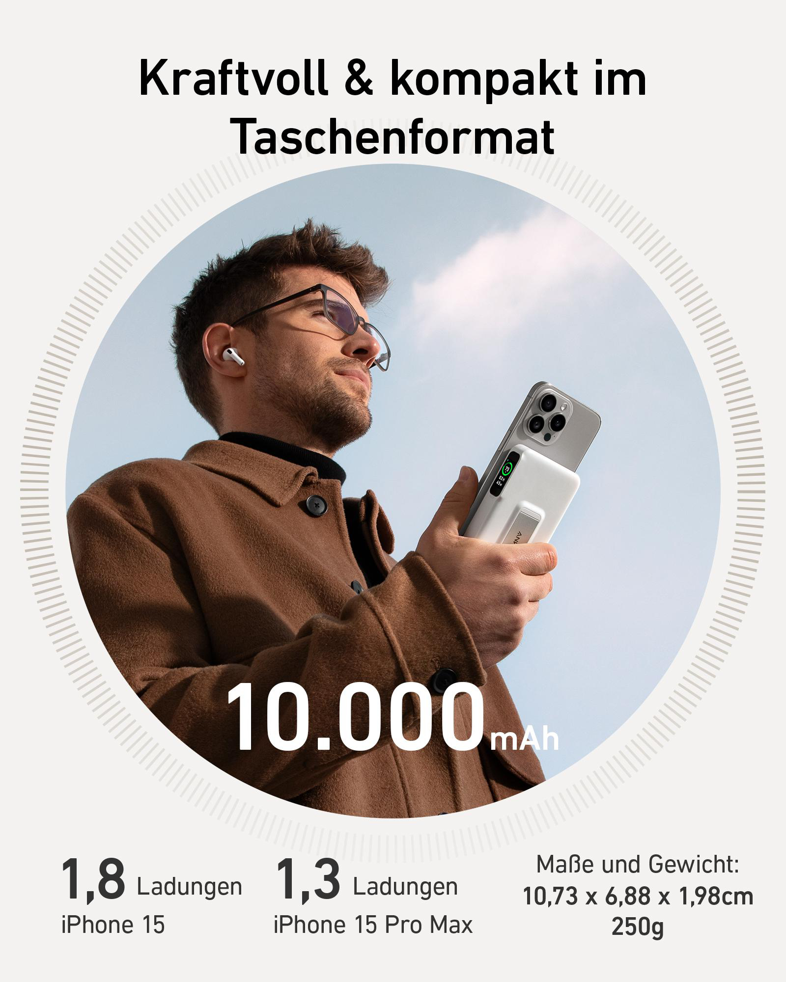 Ein Mann mit Brille hält eine weiße Powerbank, die ein silbernes Telefon lädt.