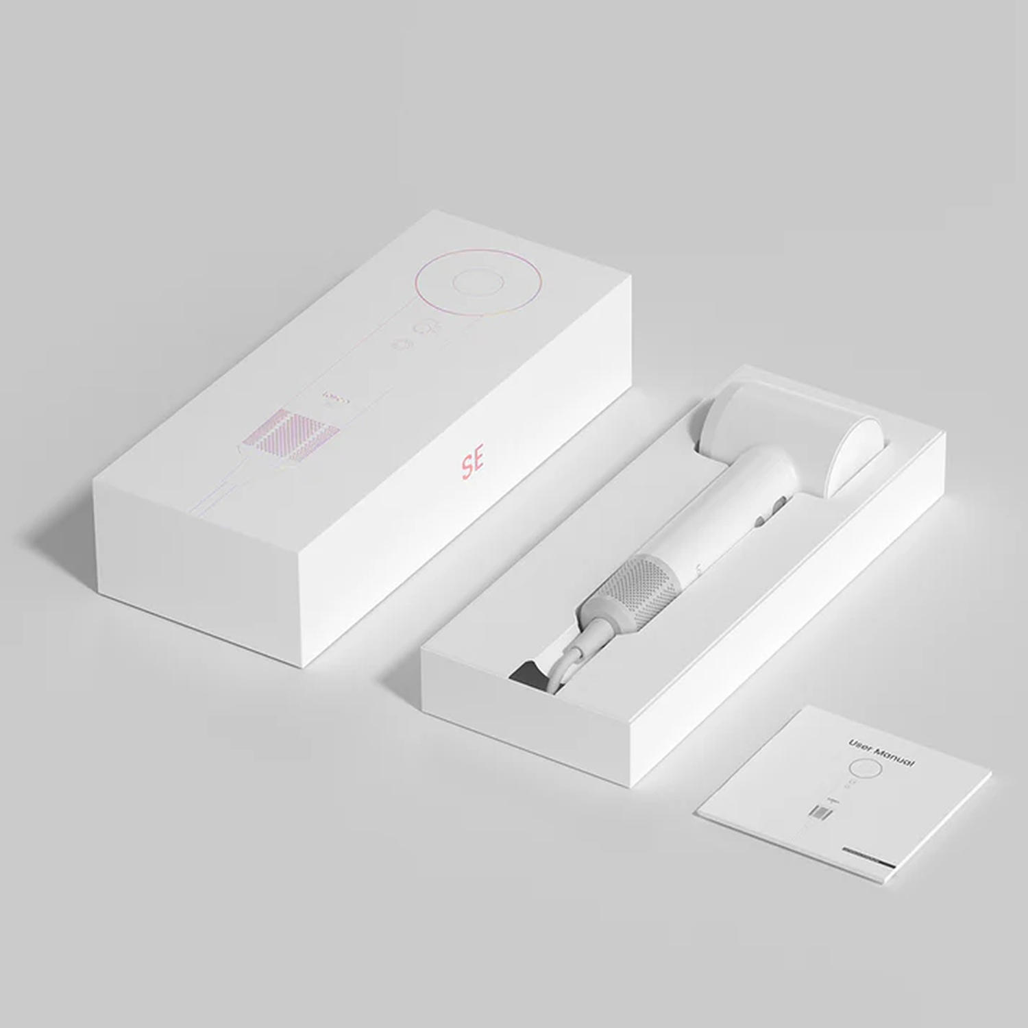 Scatola bianca con kit cacciavite elettrico bianco smontato e manuale.