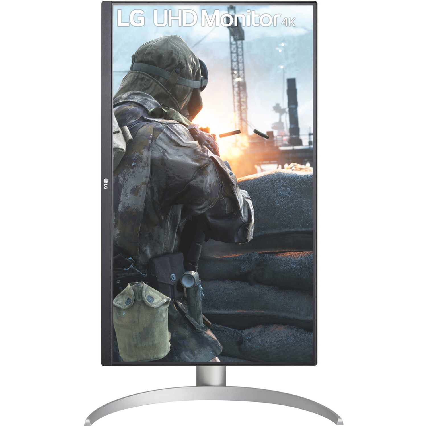 An LG UHD 4K monitor displays a soldier in a war scene with explosions and a sandbag barrier, set against a bright sky.