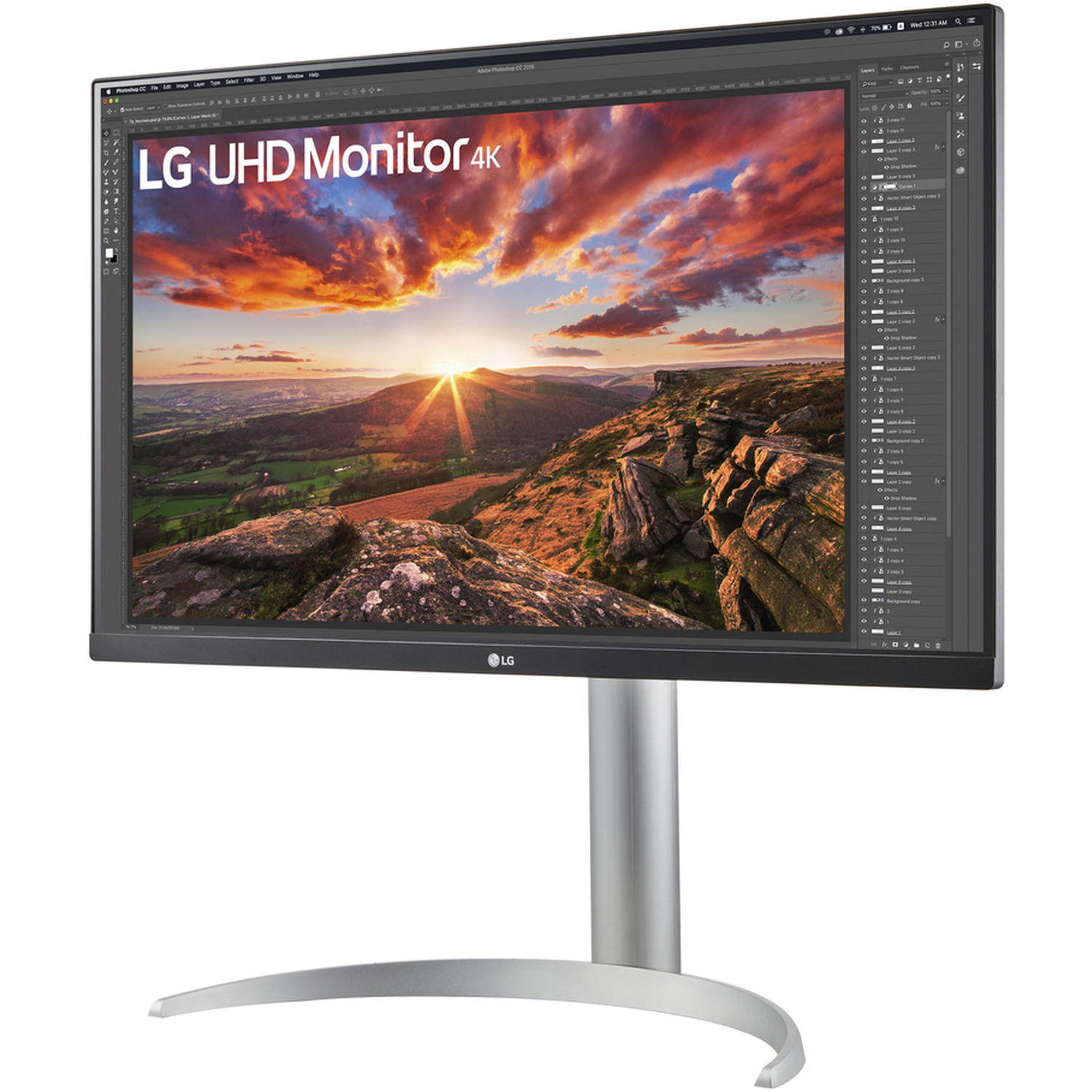 An LG UHD 4K monitor displays a landscape with sunset. The monitor is on a silver stand, and the logo is visible.