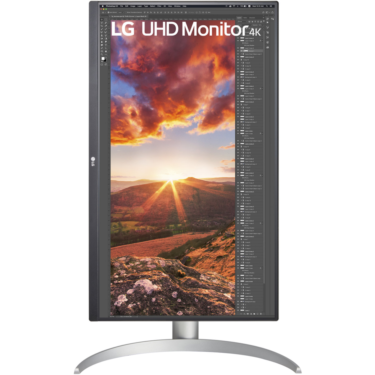 An LG UHD 4K monitor displays a sunset over hills, with Photoshop interface on the screen. The monitor has a silver stand.