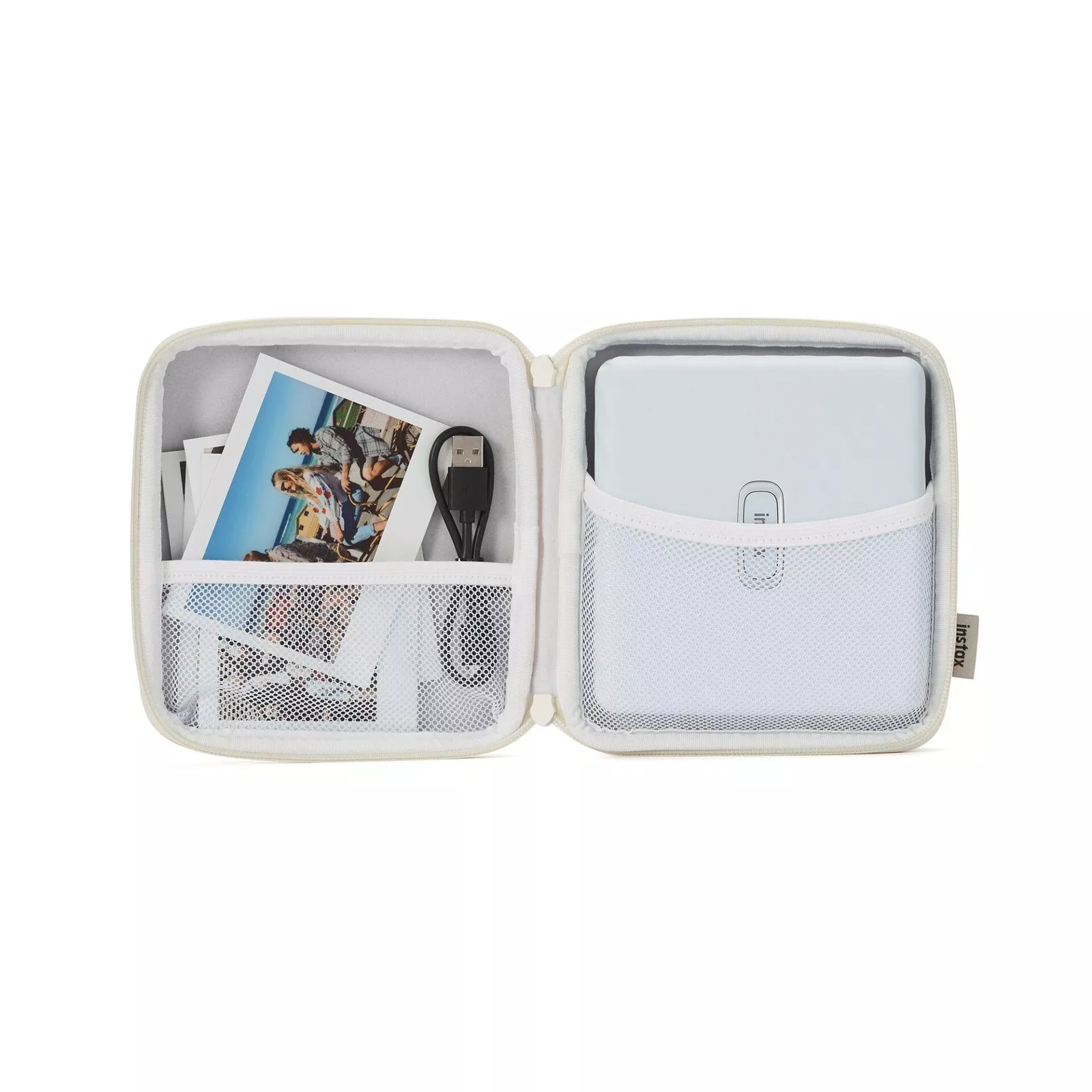 Étui blanc ouvert avec une imprimante photo, des photos et un câble de chargement.
