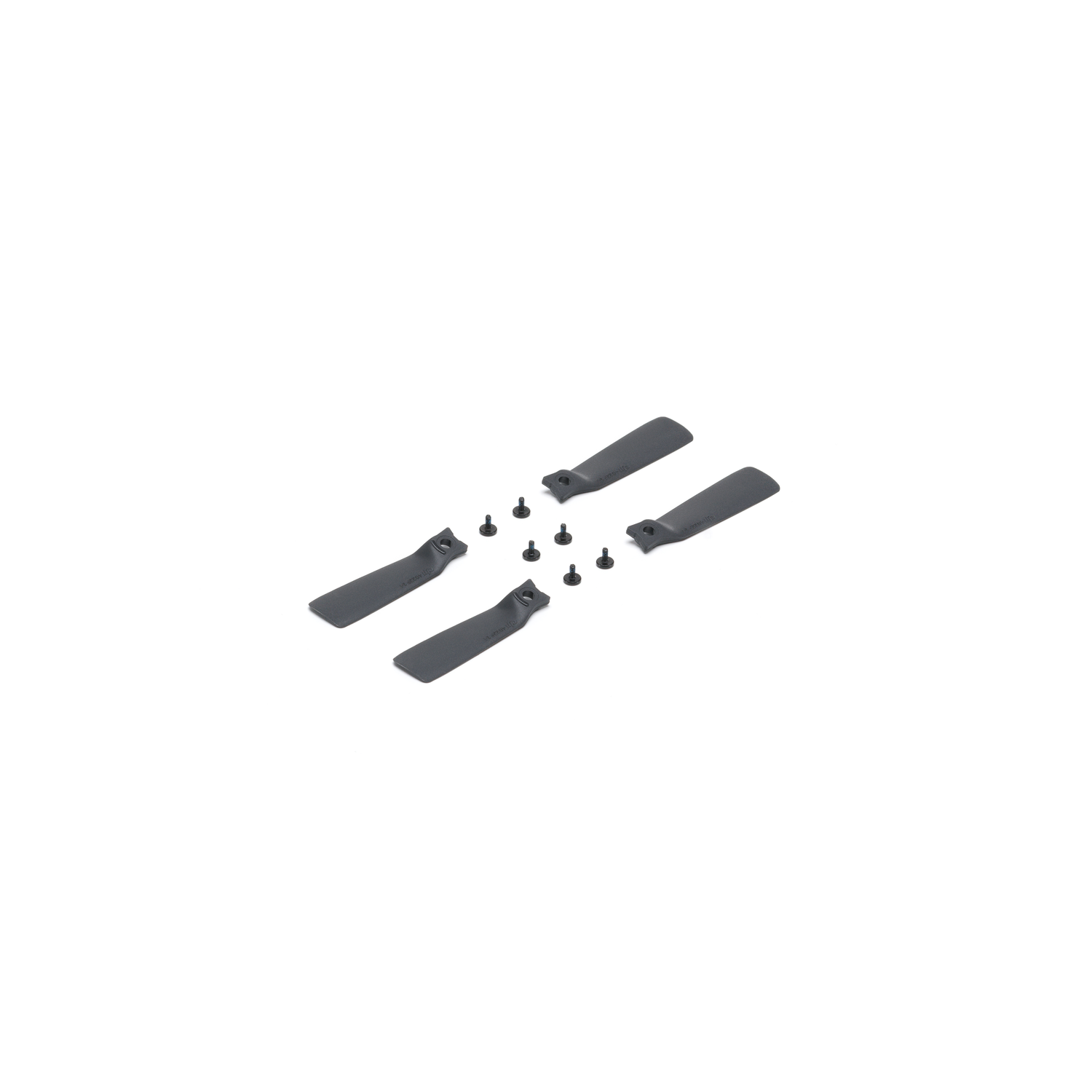 Four gray drone propellers and small screws, scattered on a white surface.