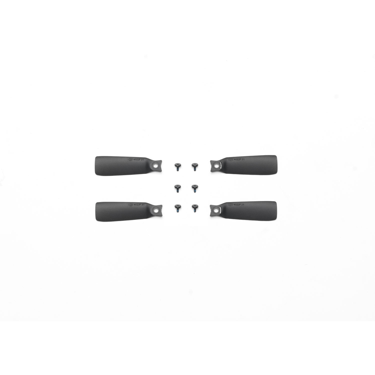 Four black drone propellers and screws are arranged on a white surface.