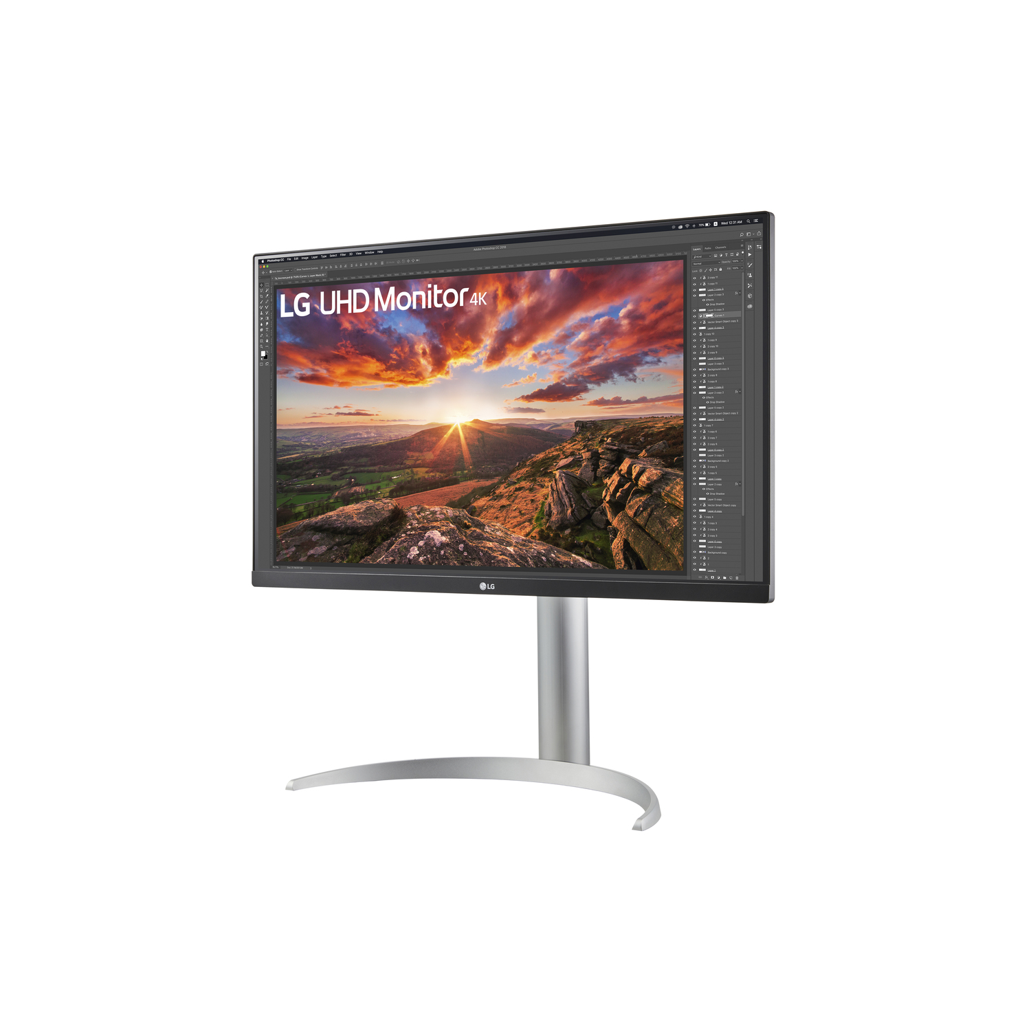LG monitor displaying an image of a sunset over a mountain range. Silver stand.