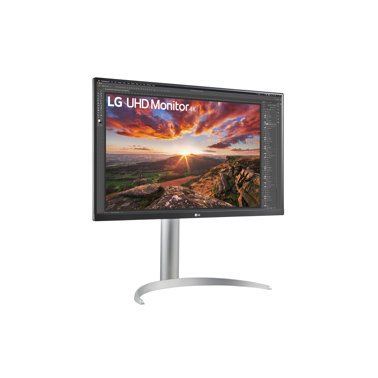 LG UHD Monitor 4K, silver stand, screen showing sunset, desktop.