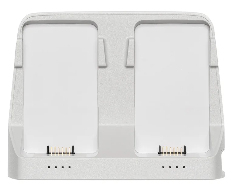 Dwie białe stacje ładowania. Prostokątny design, z portami ładowania. Szara podstawa.