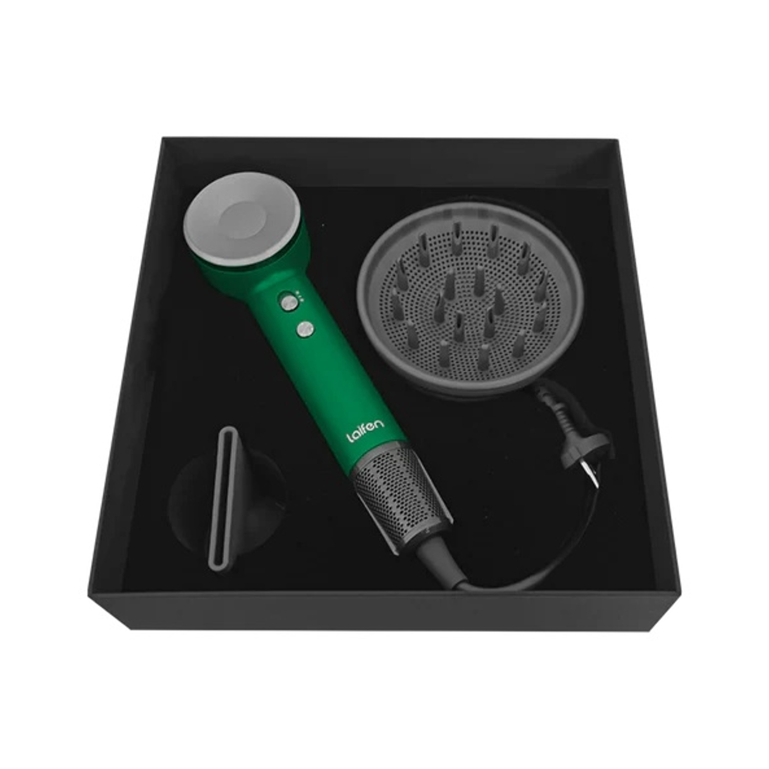 Asciugacapelli e accessori in una scatola nera. L'asciugacapelli è verde e gli accessori grigi.
