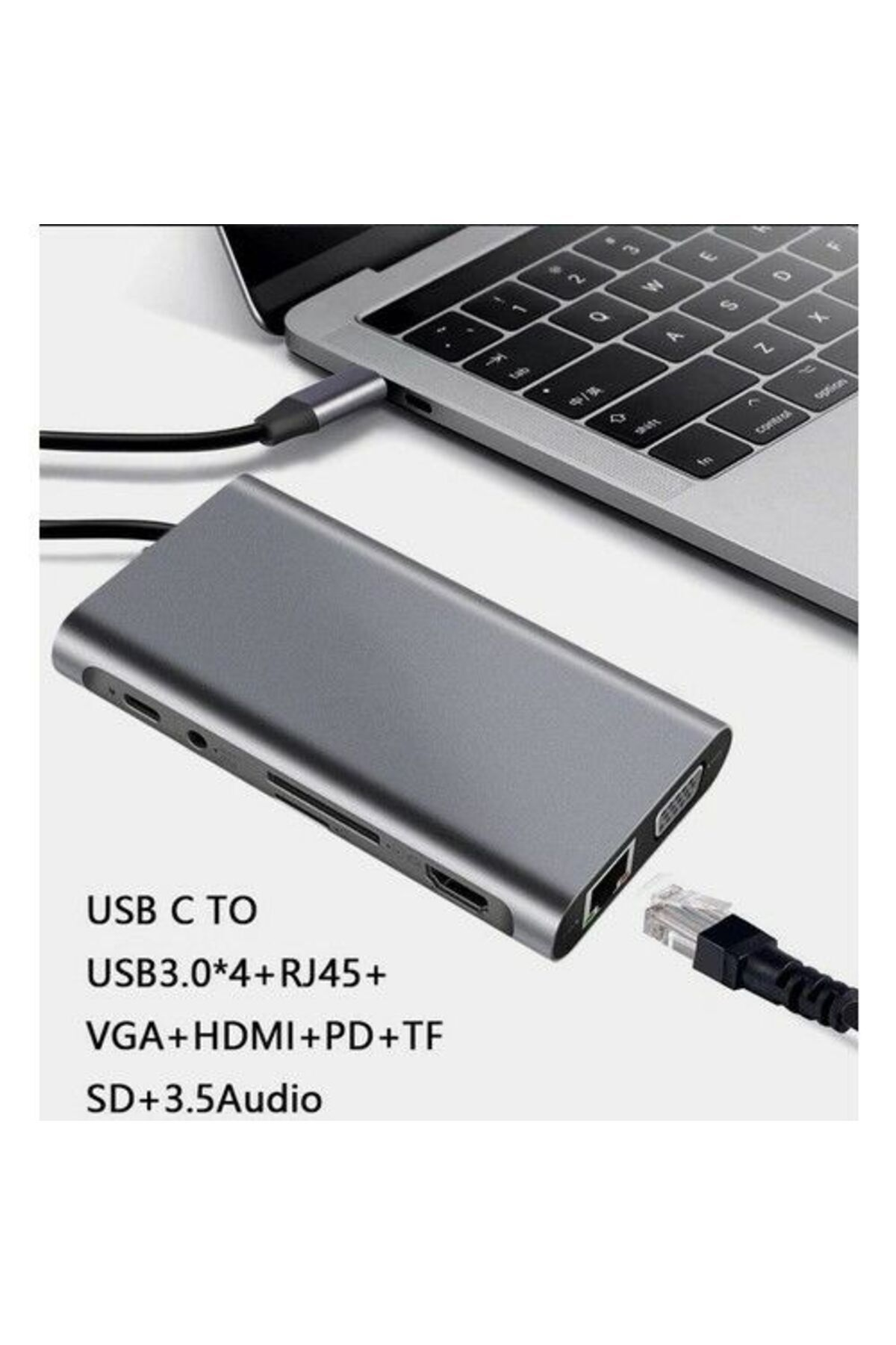 USB-C üzerinden bir dizüstü bilgisayara bağlı gri bir hub, çeşitli bağlantı noktalarıyla.