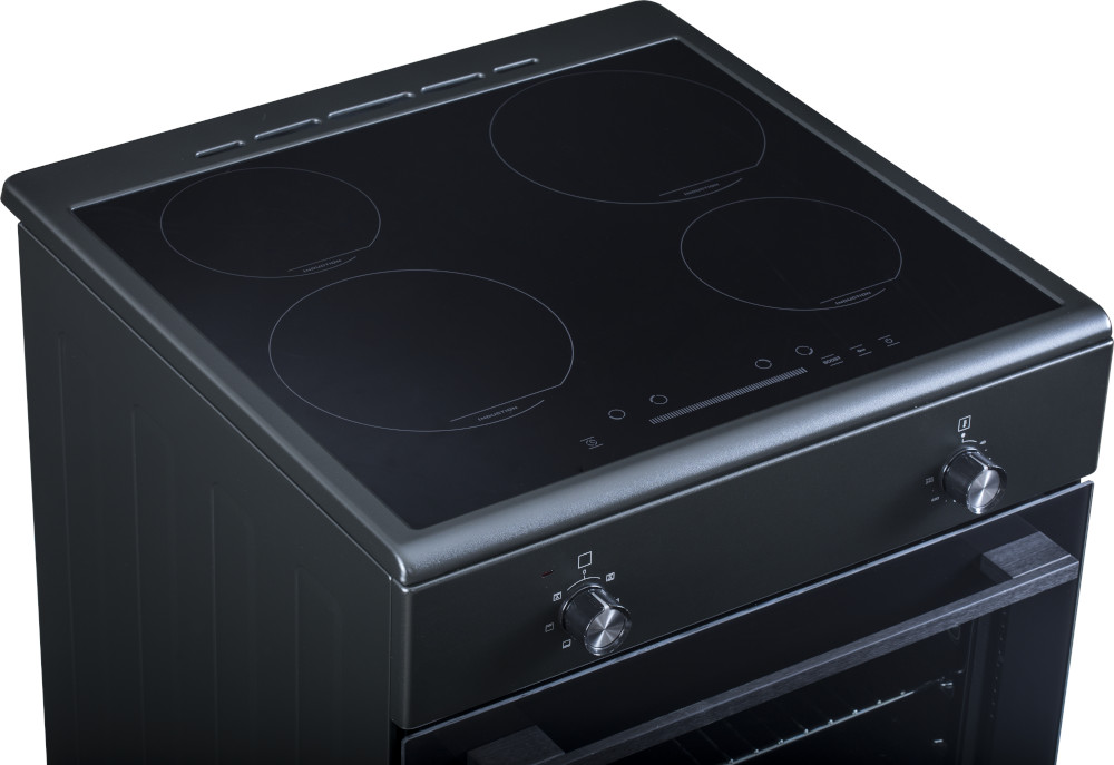 Black electric cooktop with four burners on top of an oven.