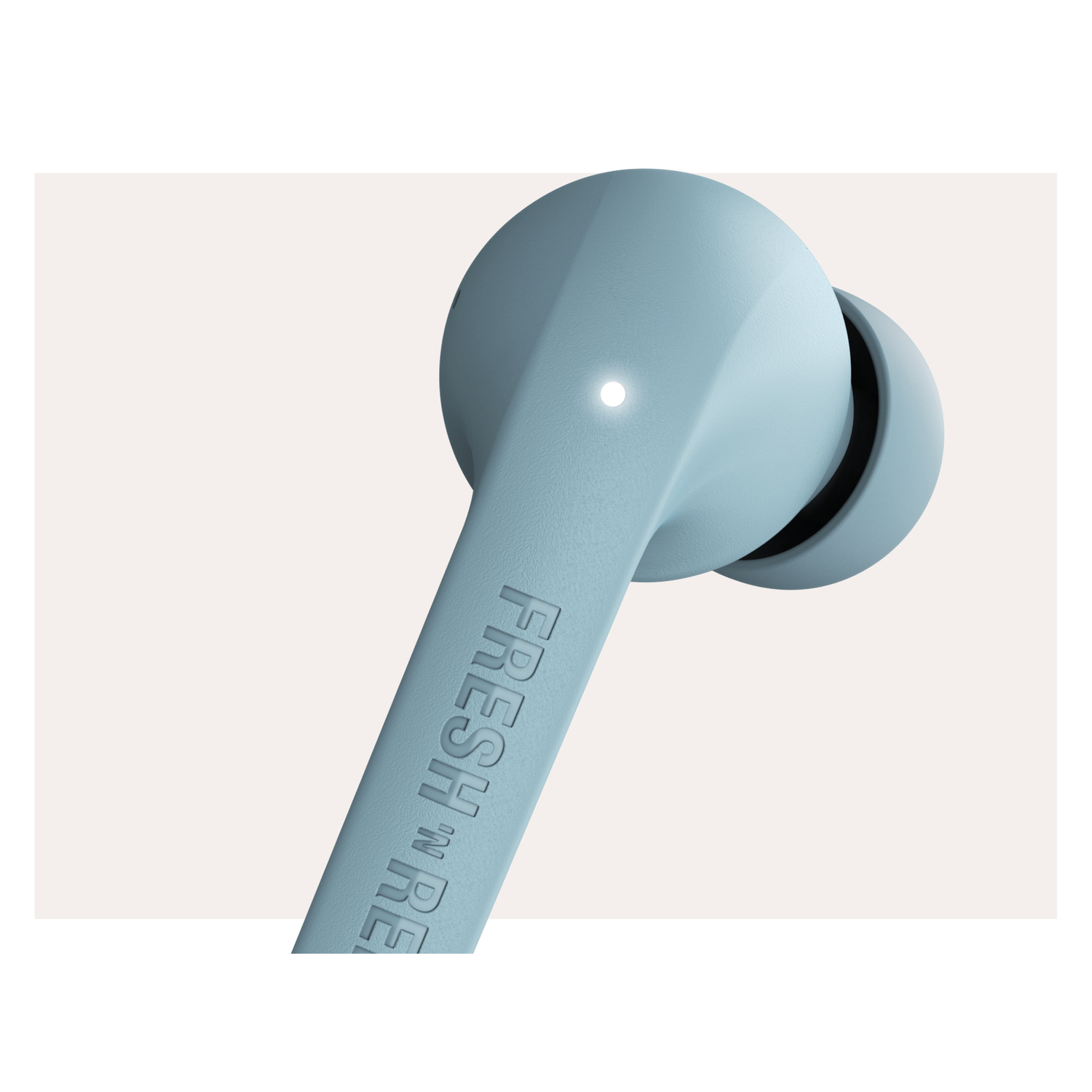Close-up of a blue earbud with the text 'FRESH 'N RE'. The background is light.
