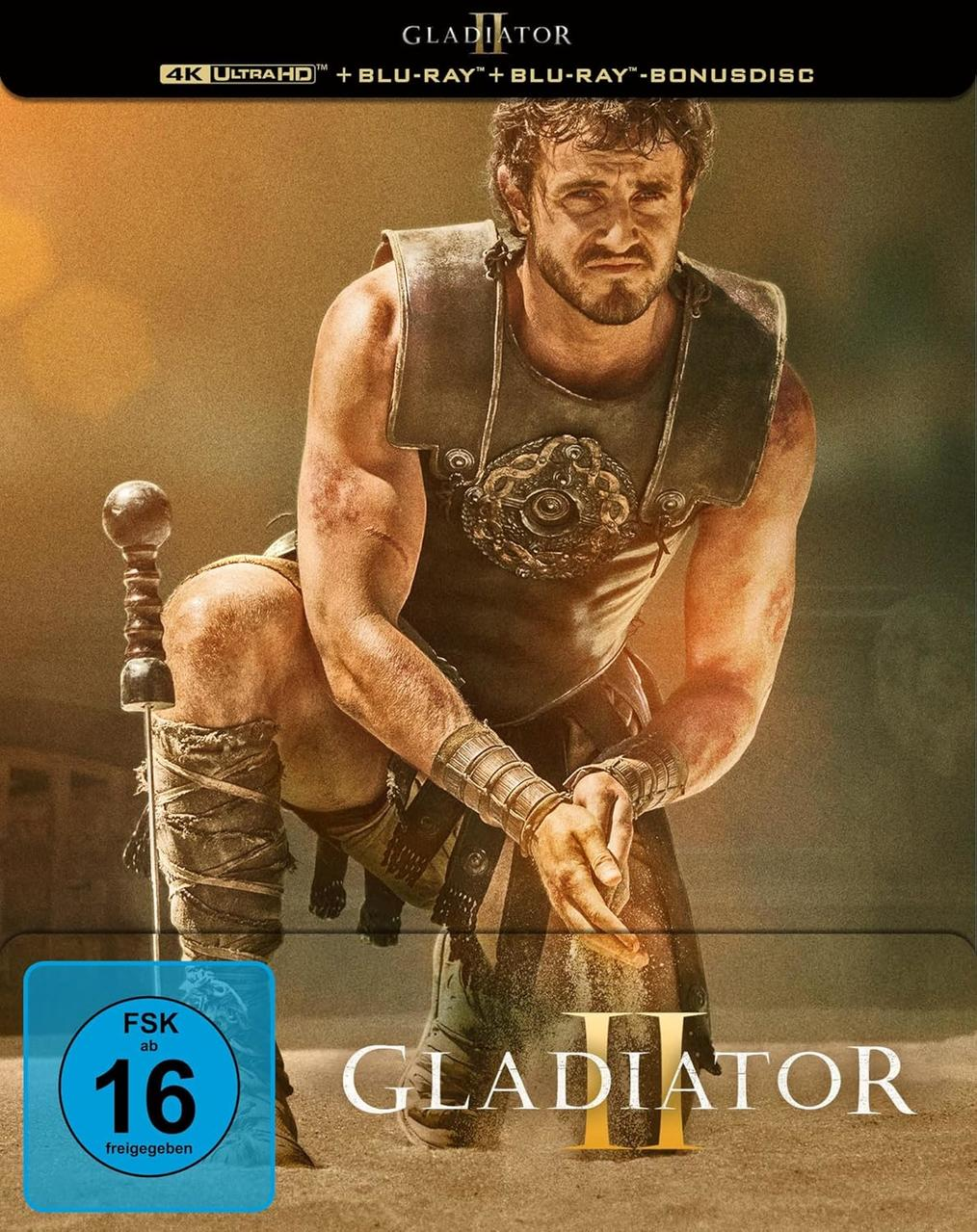 Mann in römischer Rüstung kniet mit Schwert, Filmtitel 'Gladiator II' und ein blaues FSK 16-Abzeichen.
