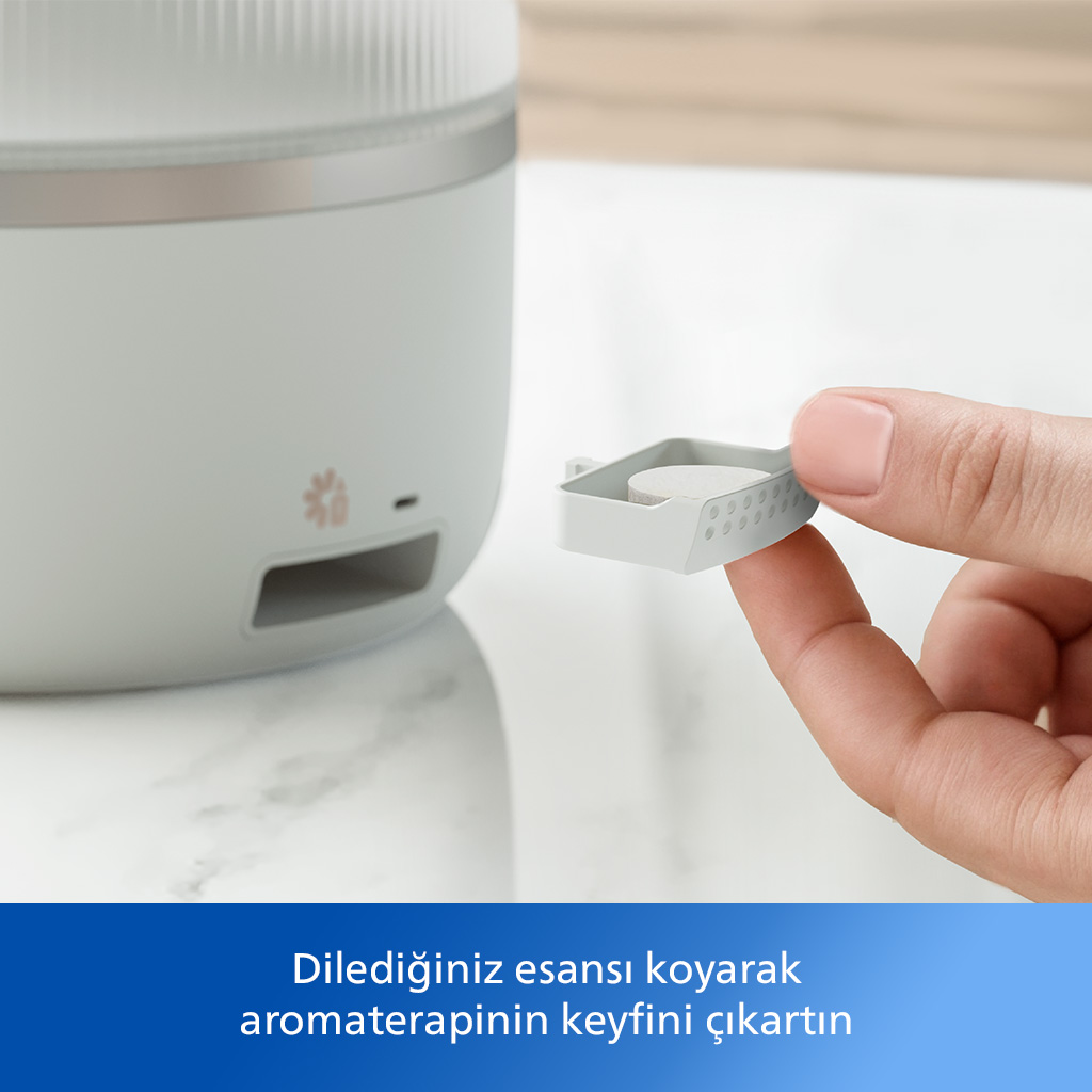 Bir el, bir difüzör ve altta Türkçe metin ile küçük beyaz bir kapsül tutuyor.