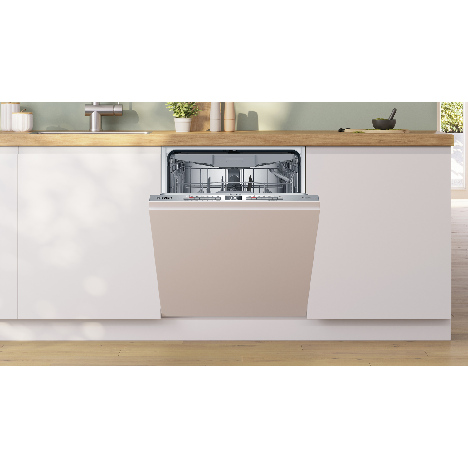 Een beige vaatwasser is geïnstalleerd in een witte keuken met houten werkbladen. De vaatwasser staat open.