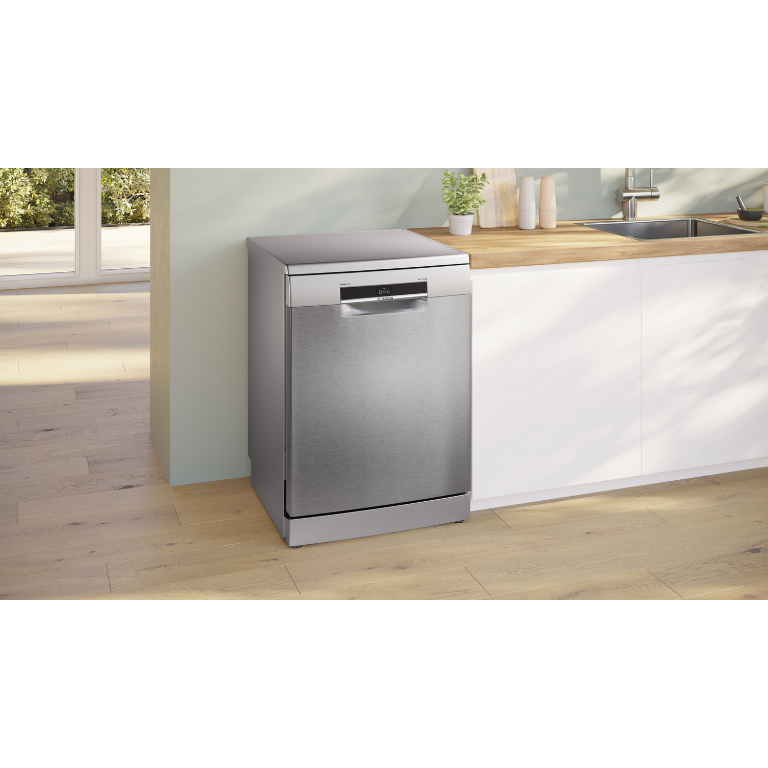 Roestvrijstalen vaatwasser in een moderne keuken, met houten vloeren en witte kasten.