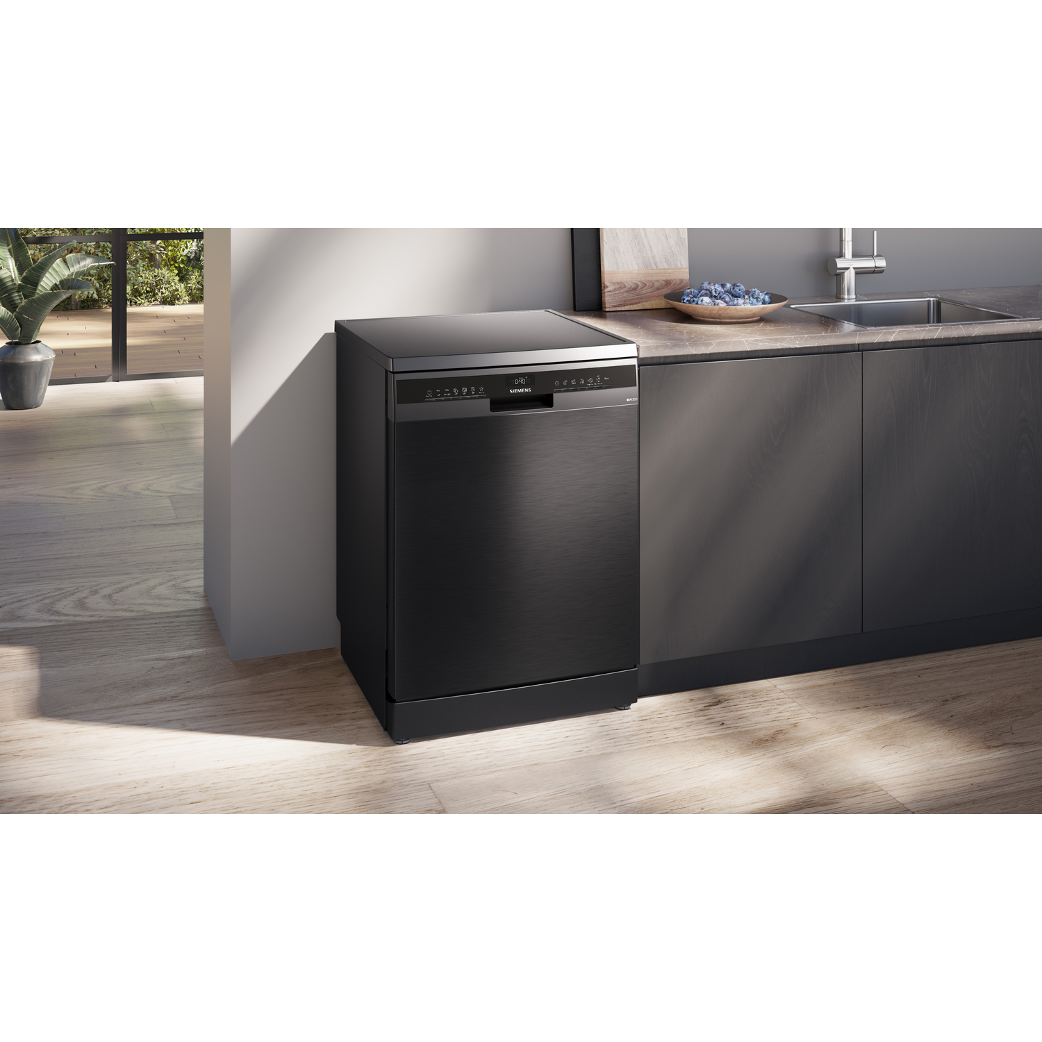 Black dishwasher in a modern kitchen setting, with a wooden floor.
