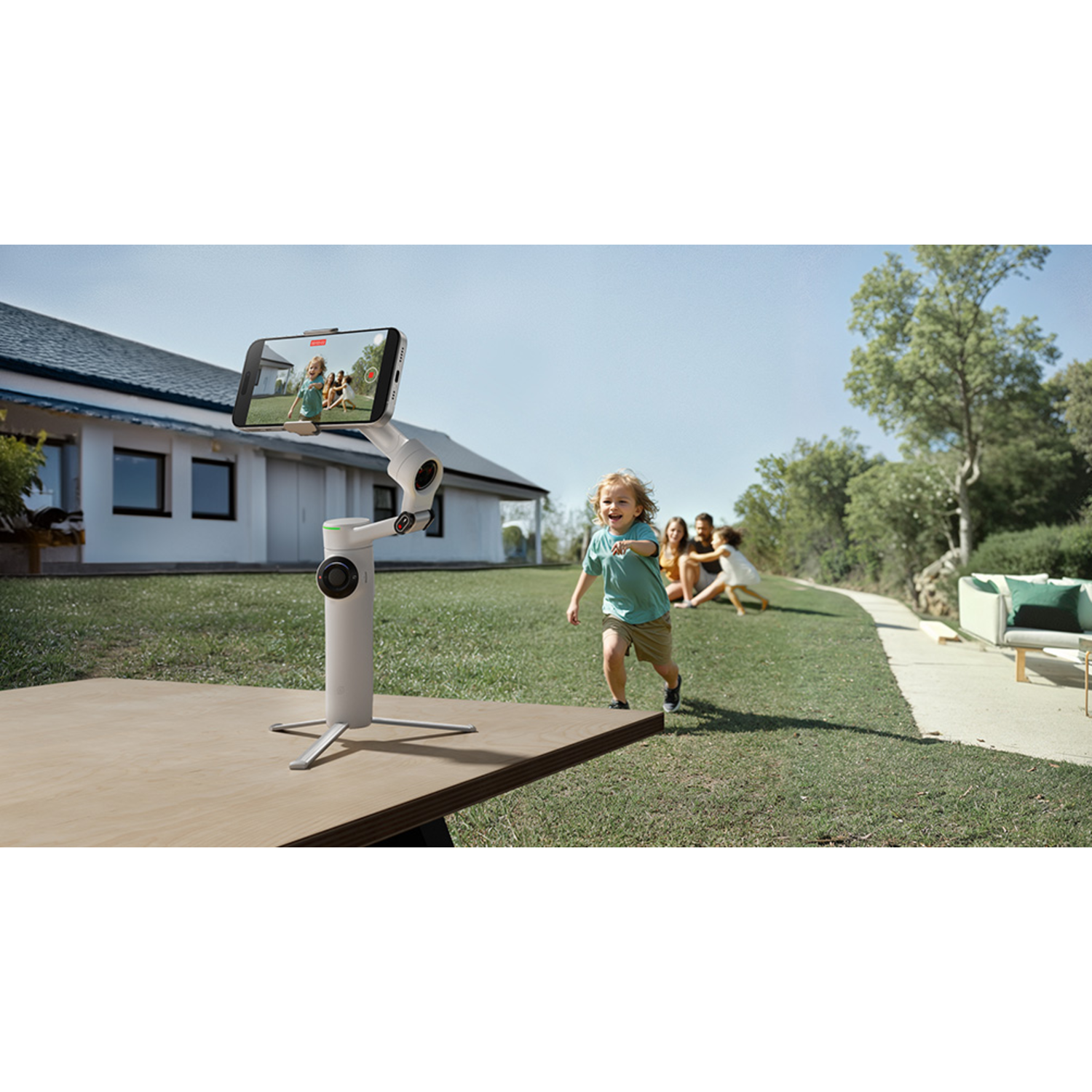 A child runs towards a phone on a stand. Other people are blurred in the background.