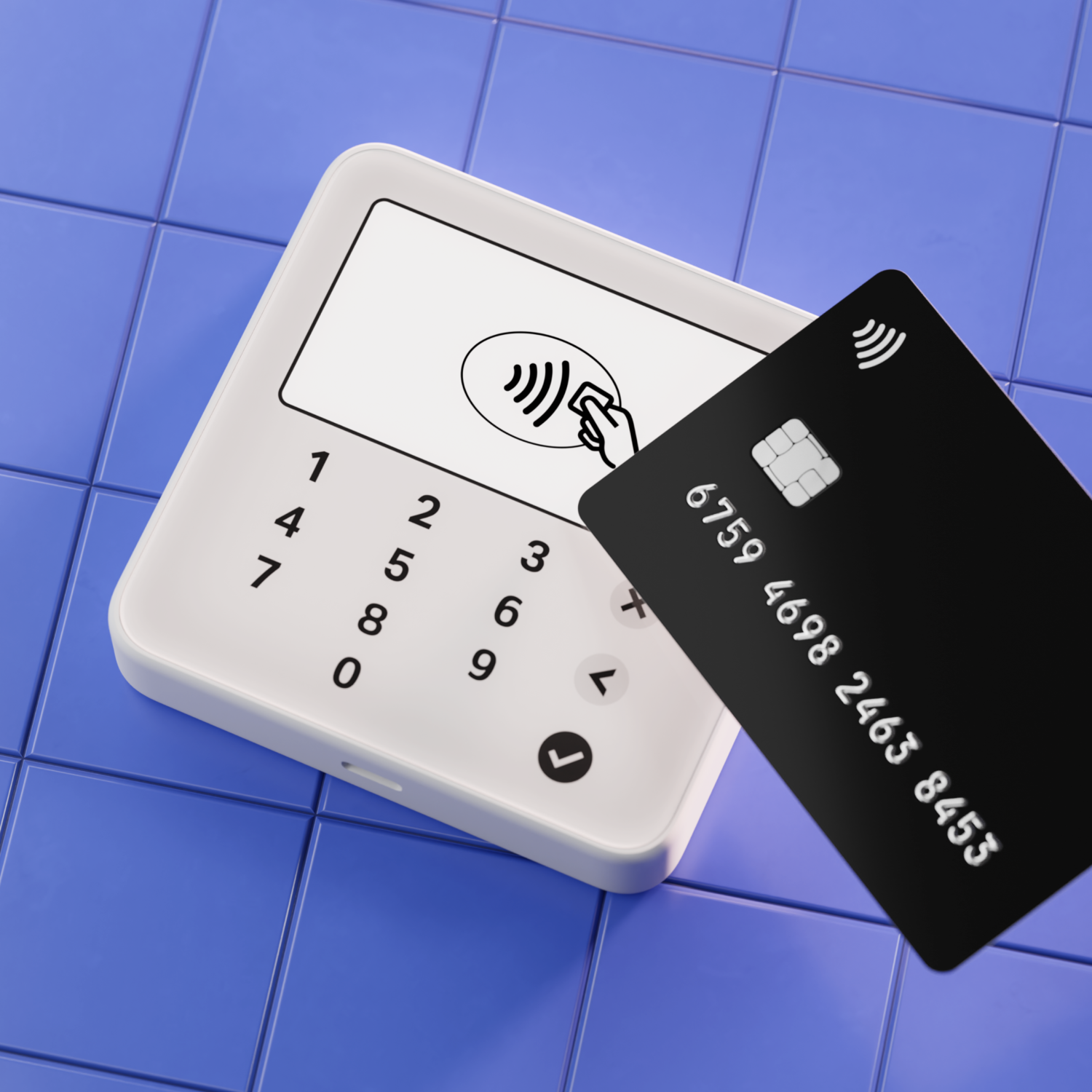 A white payment terminal and a black credit card on a blue tiled surface.