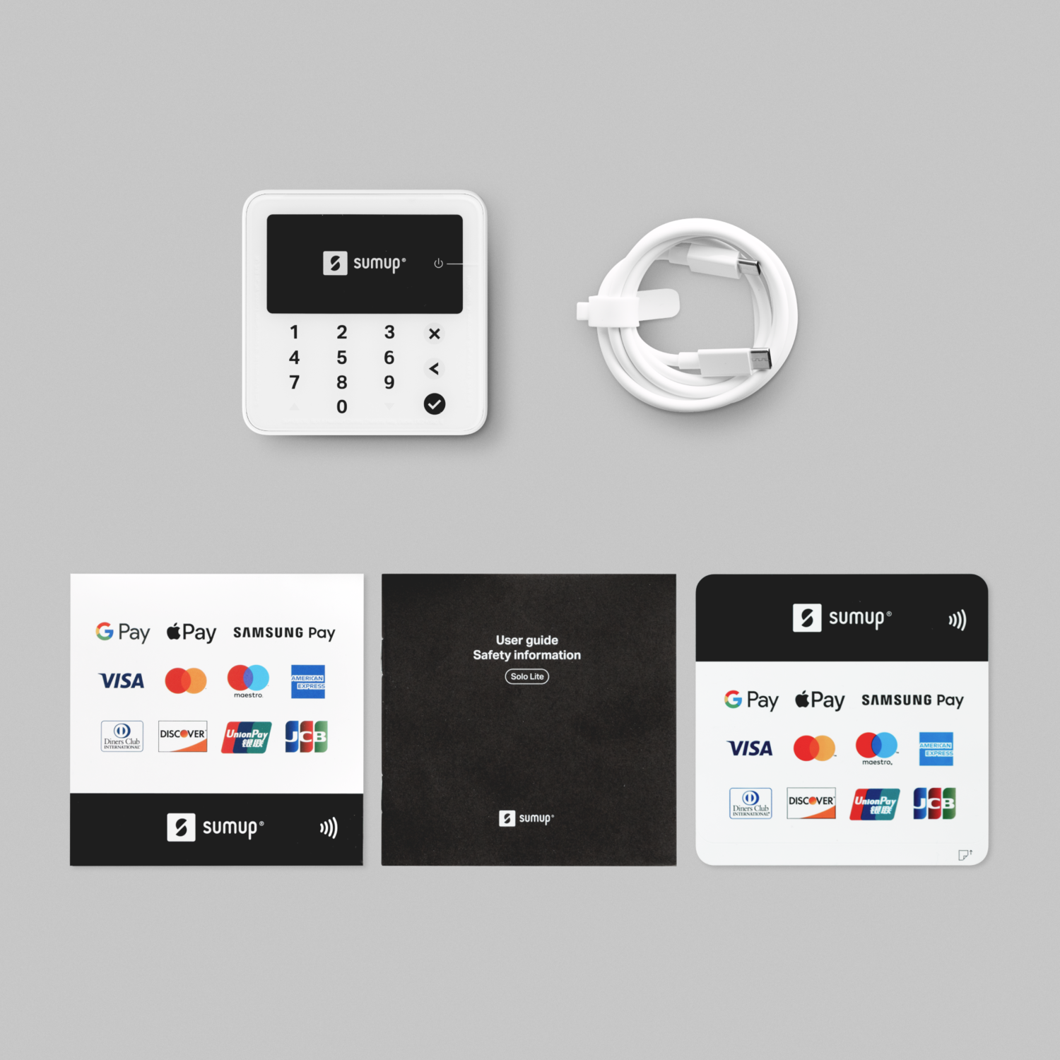 A white card reader and accessories. Includes a white cable, and user guides with payment logos.