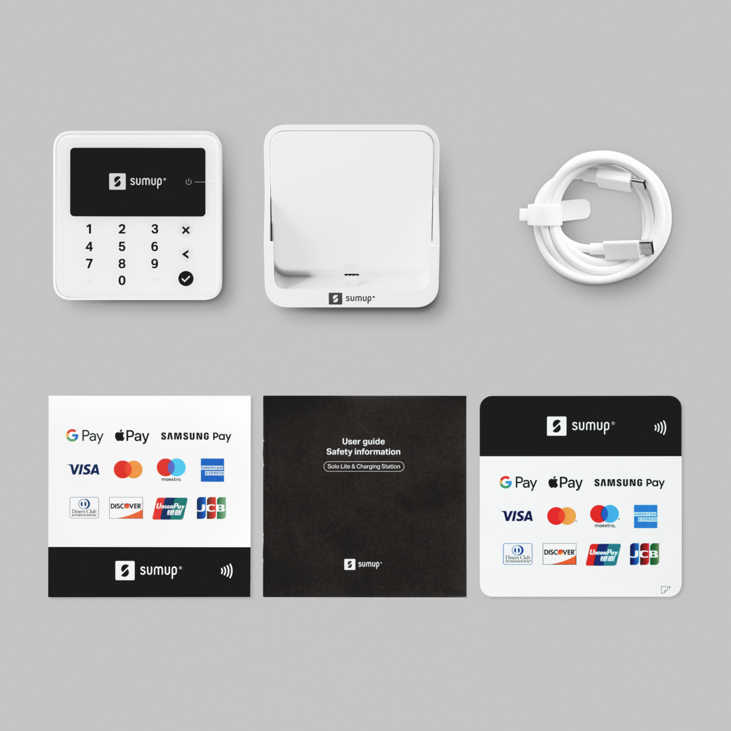 White SumUp card reader, charging dock, and cable, with payment cards logos and a user guide.