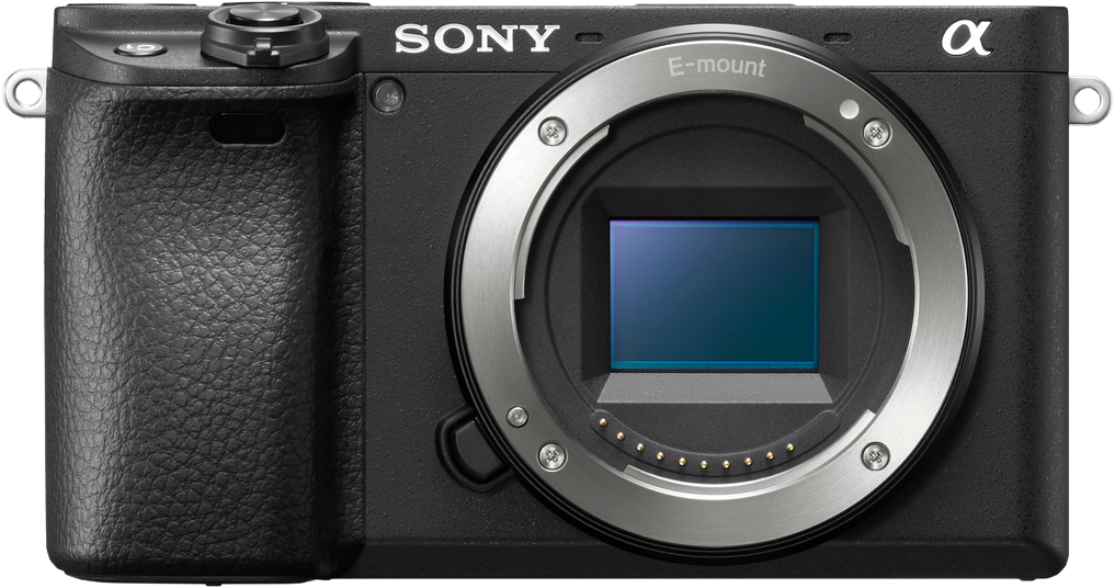 Fotocamera Sony nera, vista frontale. Obiettivo, corpo. Anello argentato attorno all'obiettivo. Logo Sony sopra.