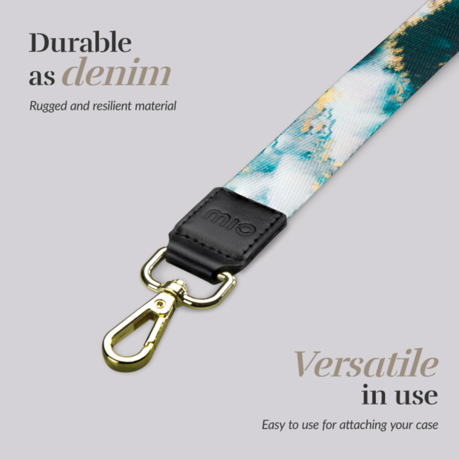 A lanyard with a floral pattern, a black leather piece, and a gold clasp.