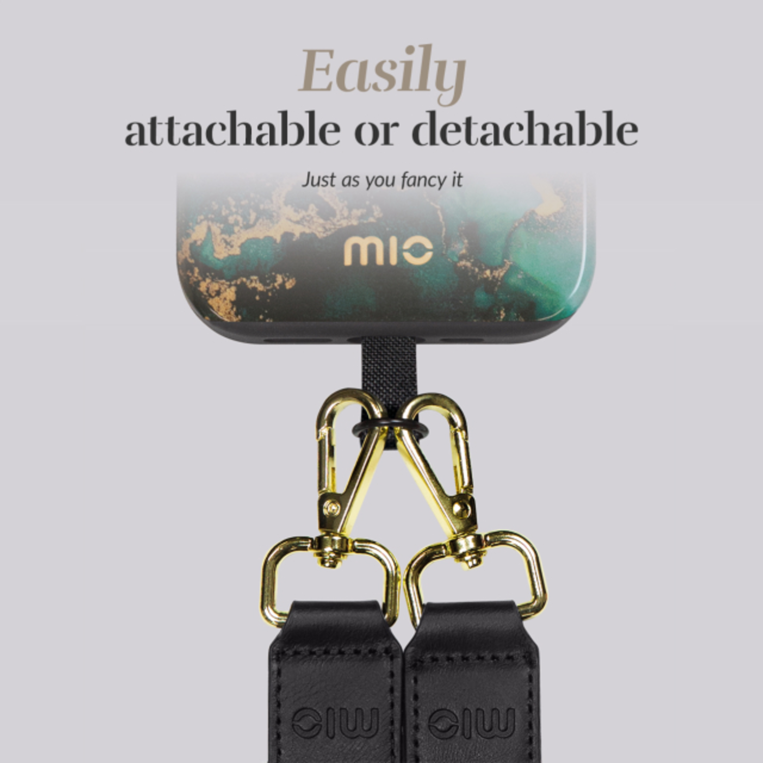 Close up of a phone case with a strap, gold clips, and the text 'mic'.