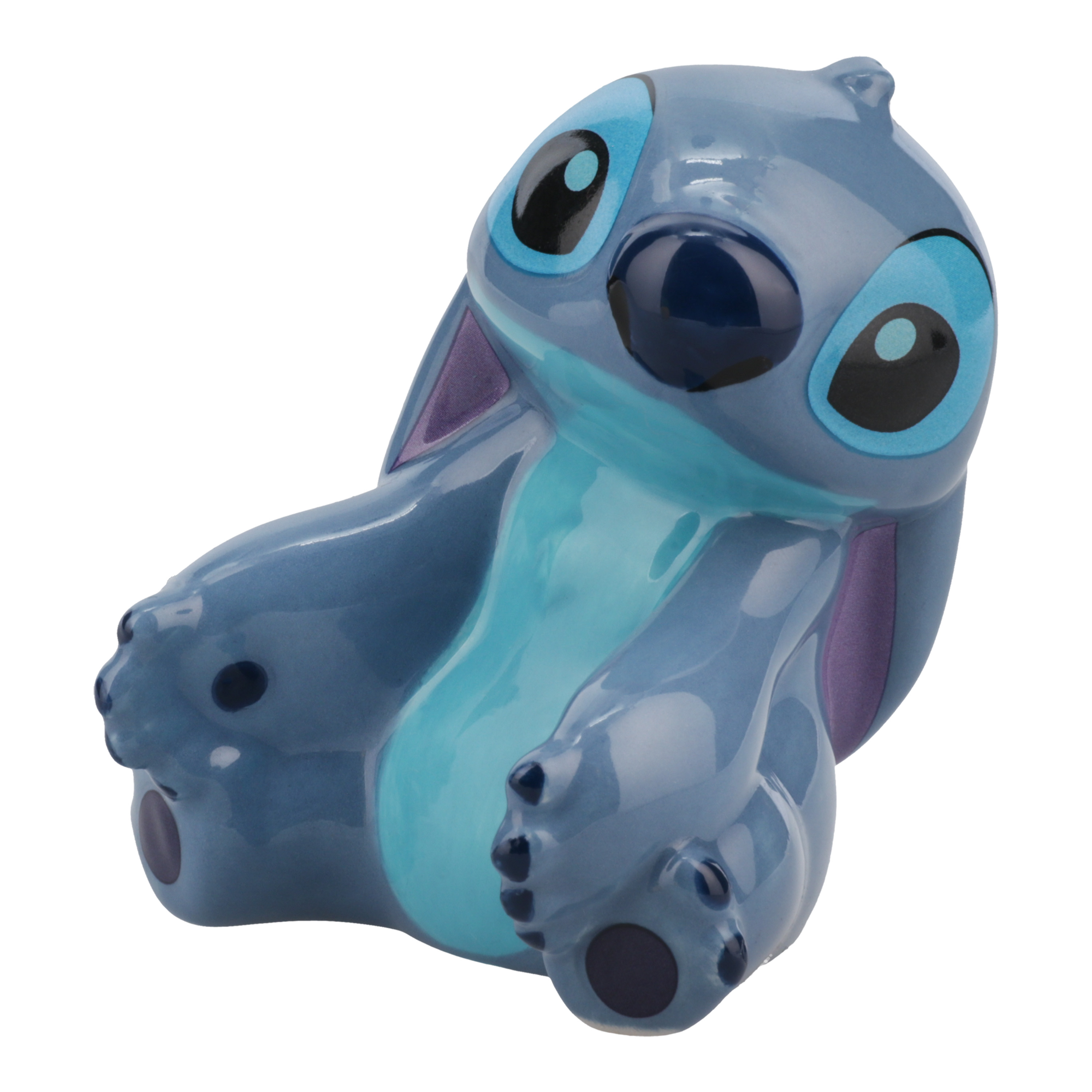 Eine blau-hellblaue Stitch-Figur. Er sitzt, lächelt und schaut zur Seite.