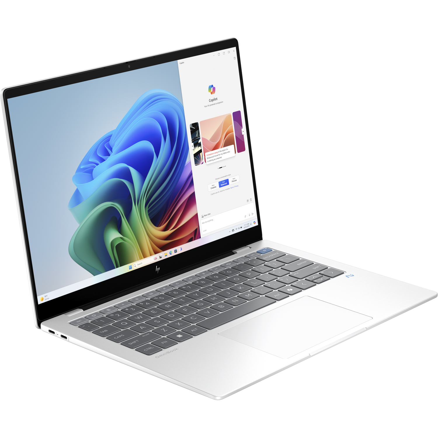 A silver laptop on a white surface, showing a screen with a colorful display.