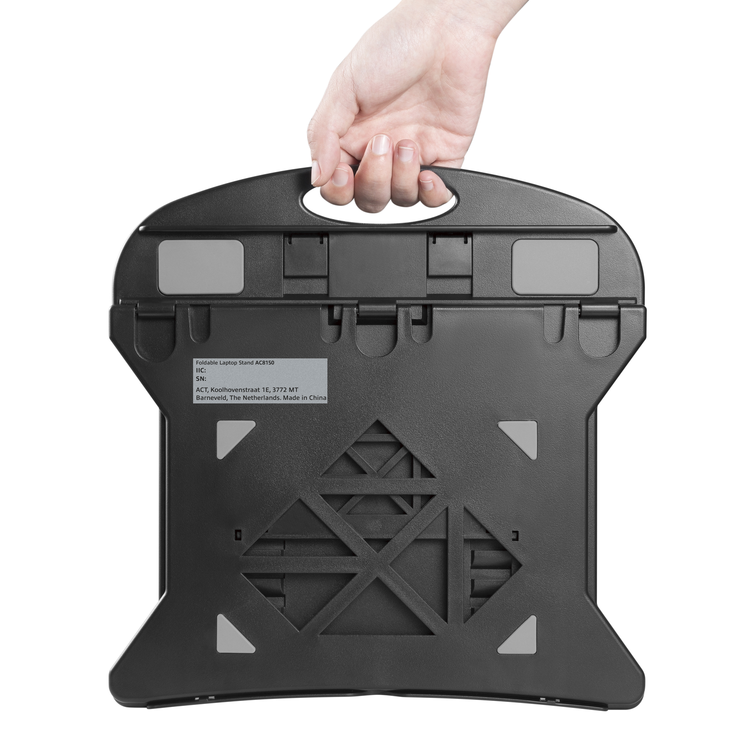 A hand holding a black laptop stand, bottom view.