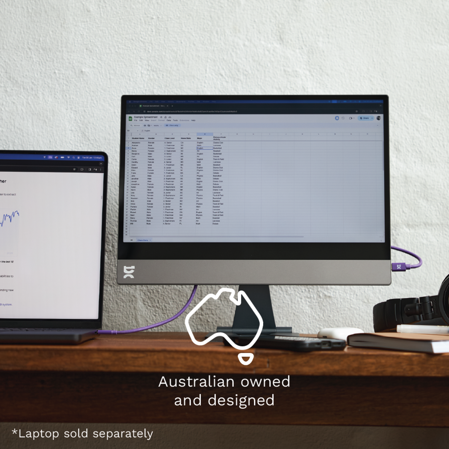 A silver laptop on a stand with an open screen, showing the Windows logo.