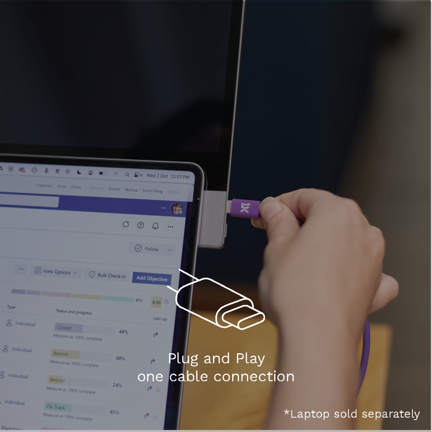 A laptop is connected to a cable that plugs into a purple port. The laptop screen shows a page.