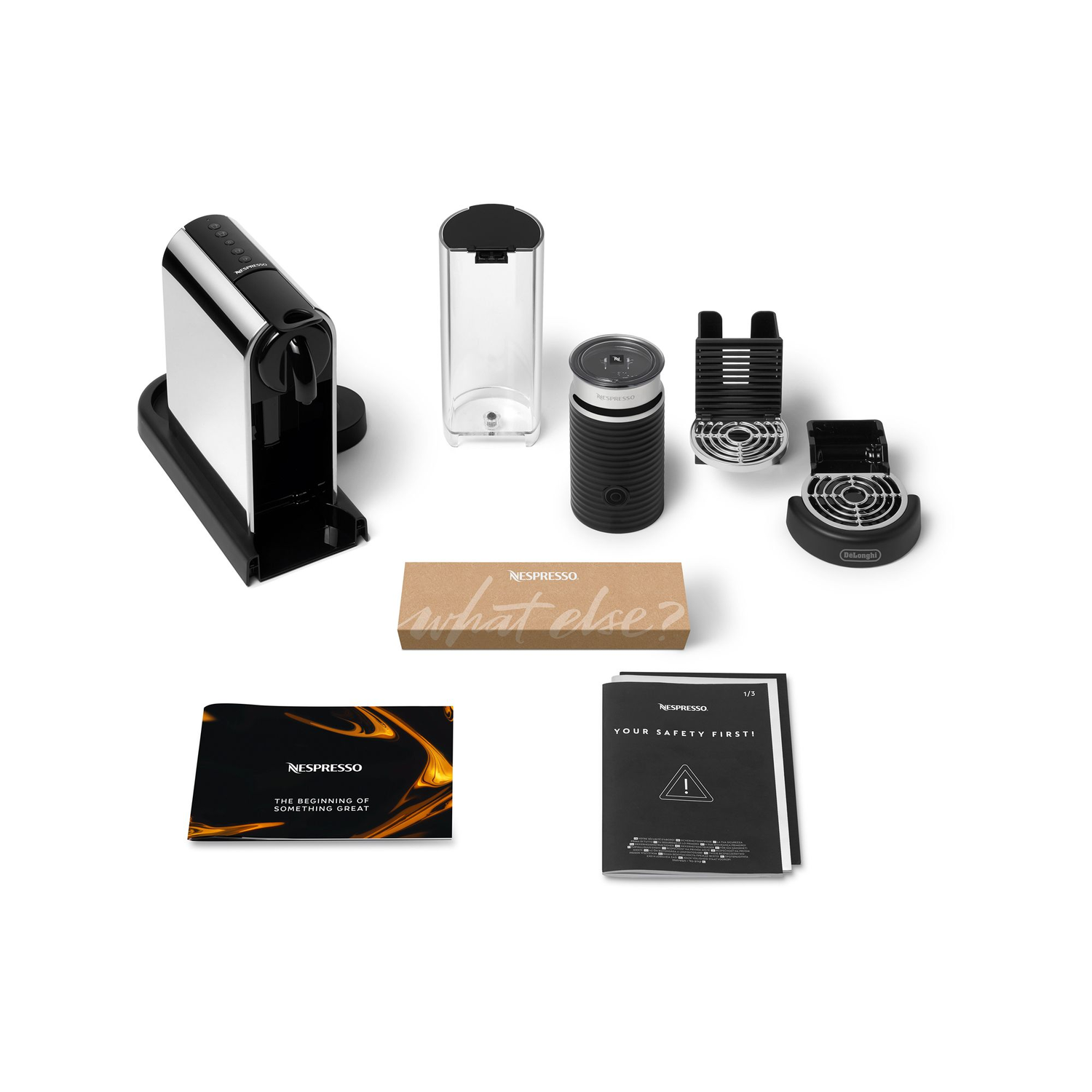 Nespresso coffee machine and accessories. Includes machine, frother, and various components.