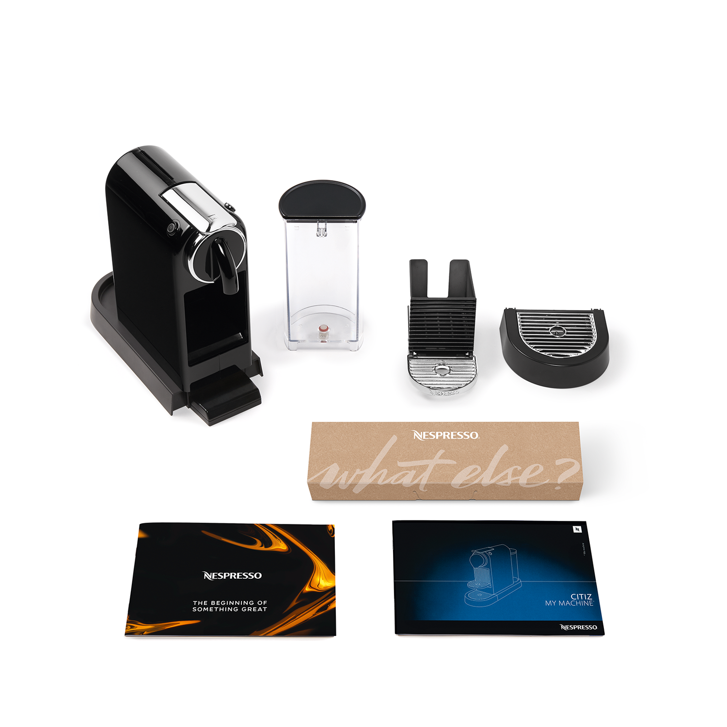 Nespresso-koffiemachine en accessoires, waaronder een watertank en een doos met "what else?".
