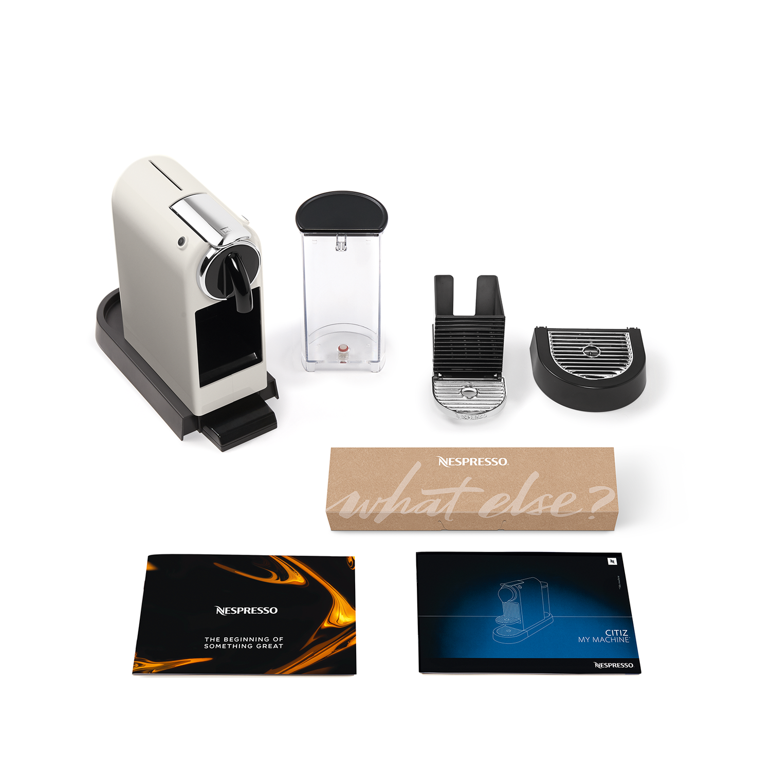 Nespresso coffee machine and accessories. Includes the machine, water tank, and coffee pods.