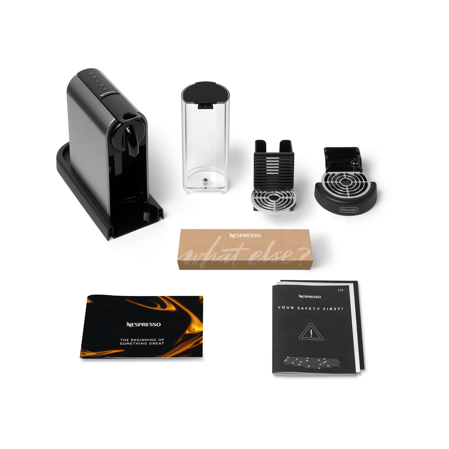 Nespresso coffee machine and accessories, including a water tank and box that says, "what else?".
