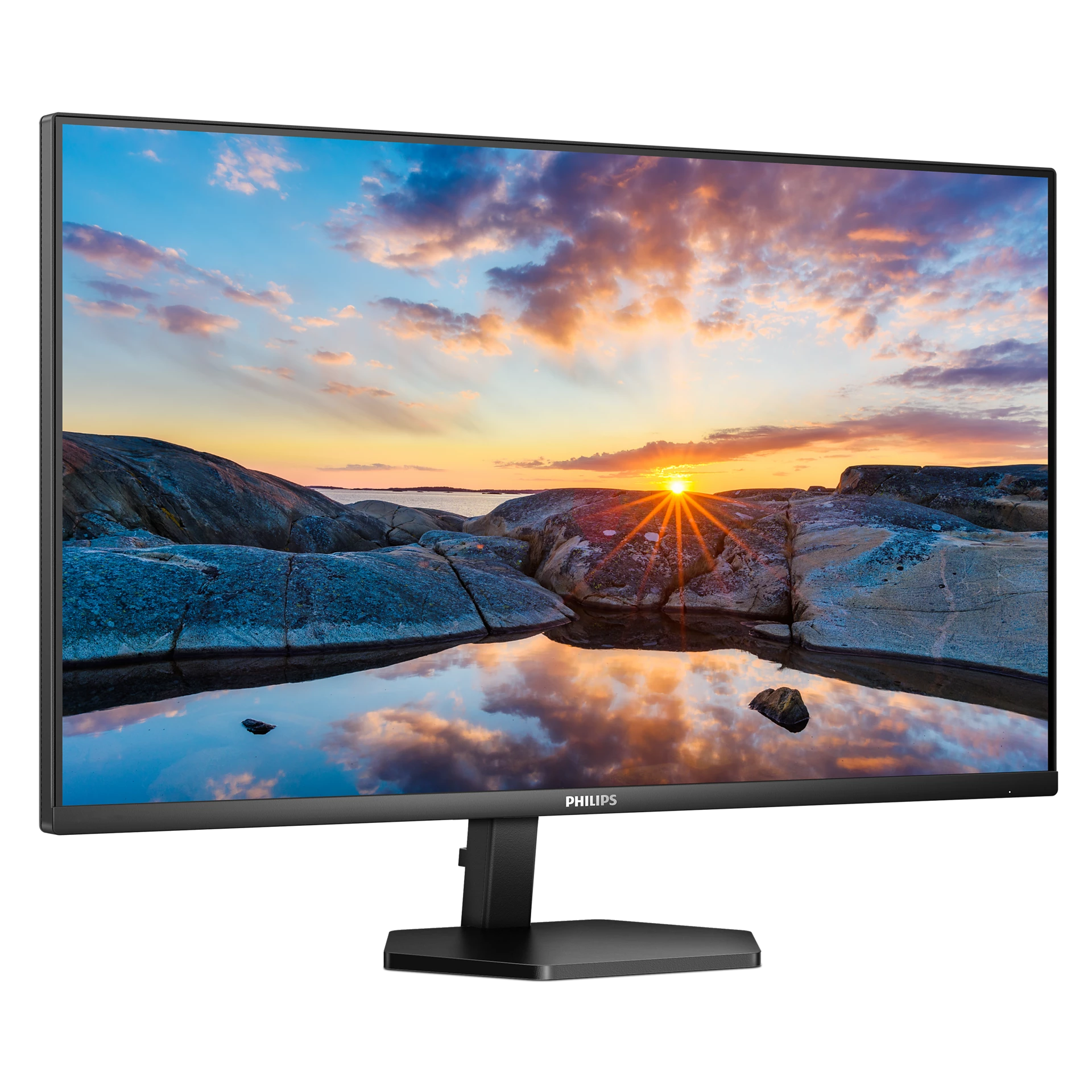 Un monitor de computadora que muestra una hermosa puesta de sol sobre una costa rocosa.