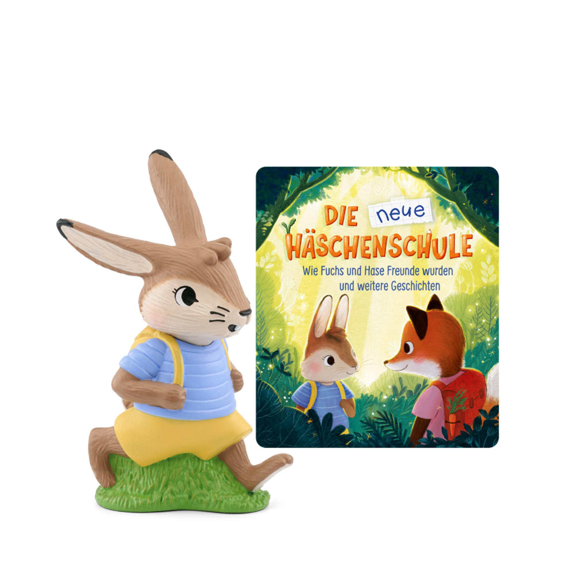Ein Spielzeug-Kaninchen neben einem Buch. Das Buch zeigt ein Kaninchen und einen Fuchs. Sie tragen Rucksäcke.
