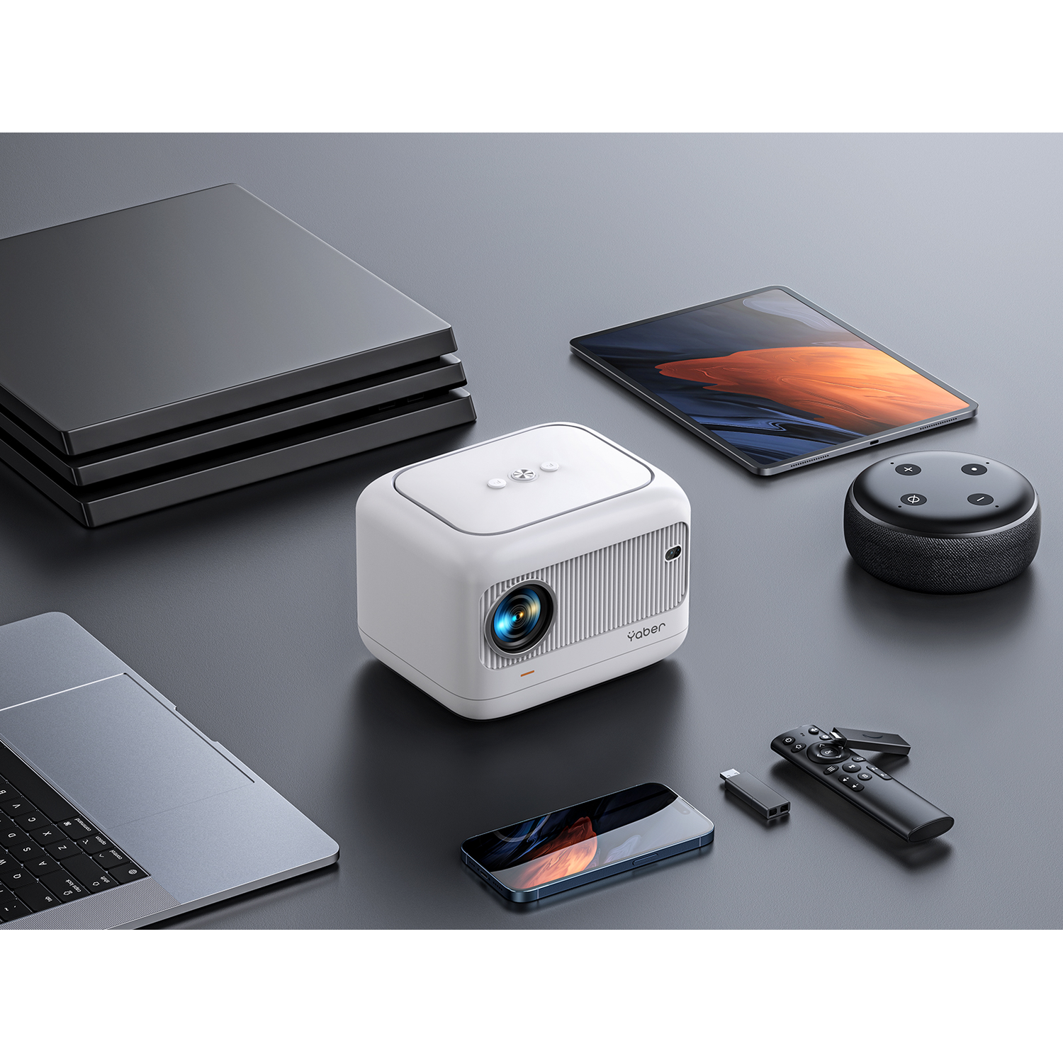 A white projector, phone, tablet, and other devices are on a gray surface.