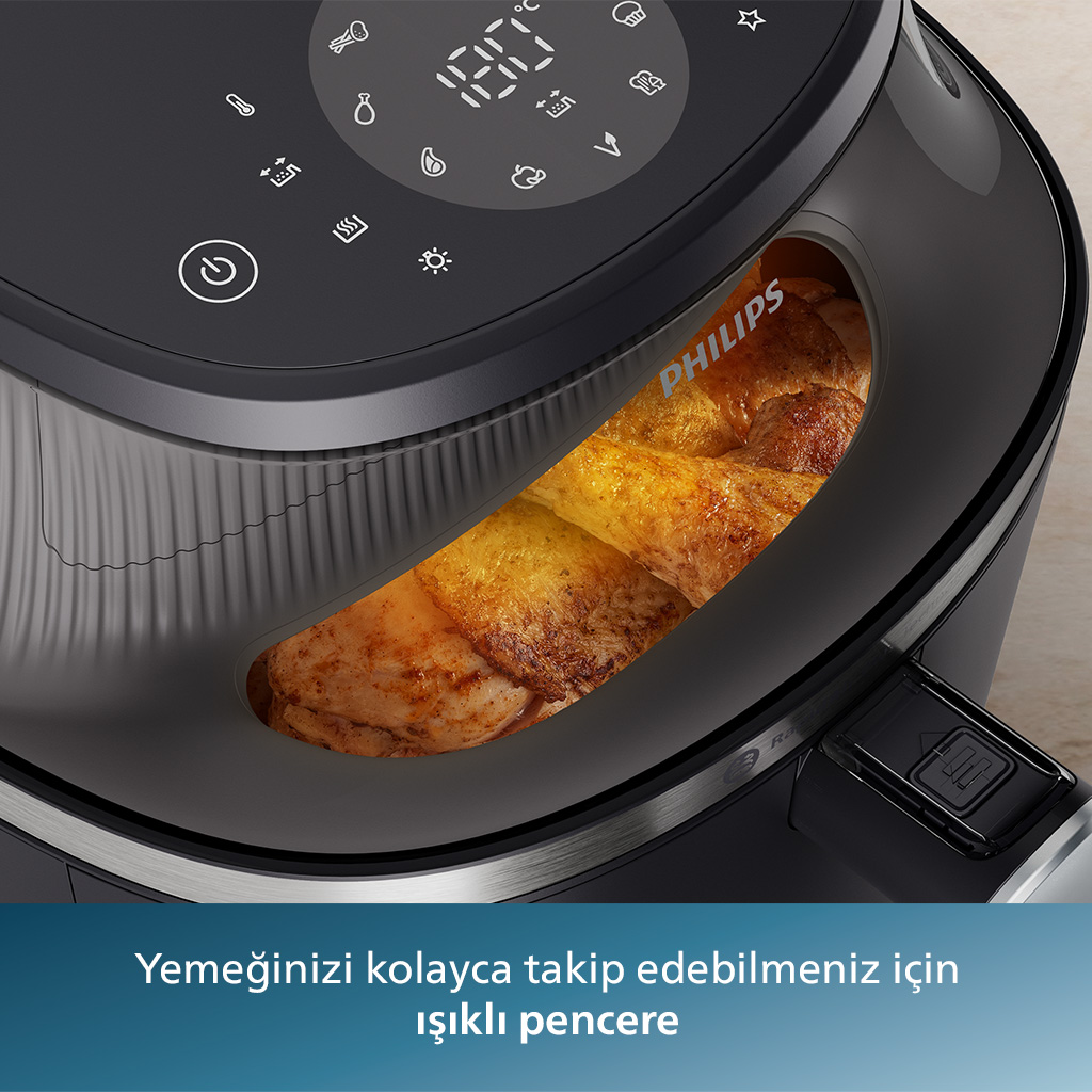 Pişmiş tavuklu Philips hava fritözü. Metin: 'Kolay yemek takibi için ışıklı pencere'.