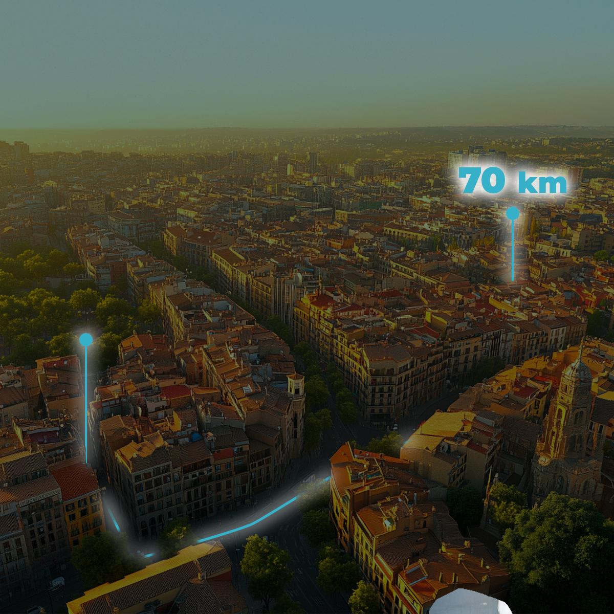 Una vista aérea de una ciudad con una flecha azul y texto que indica una distancia de 70 km.