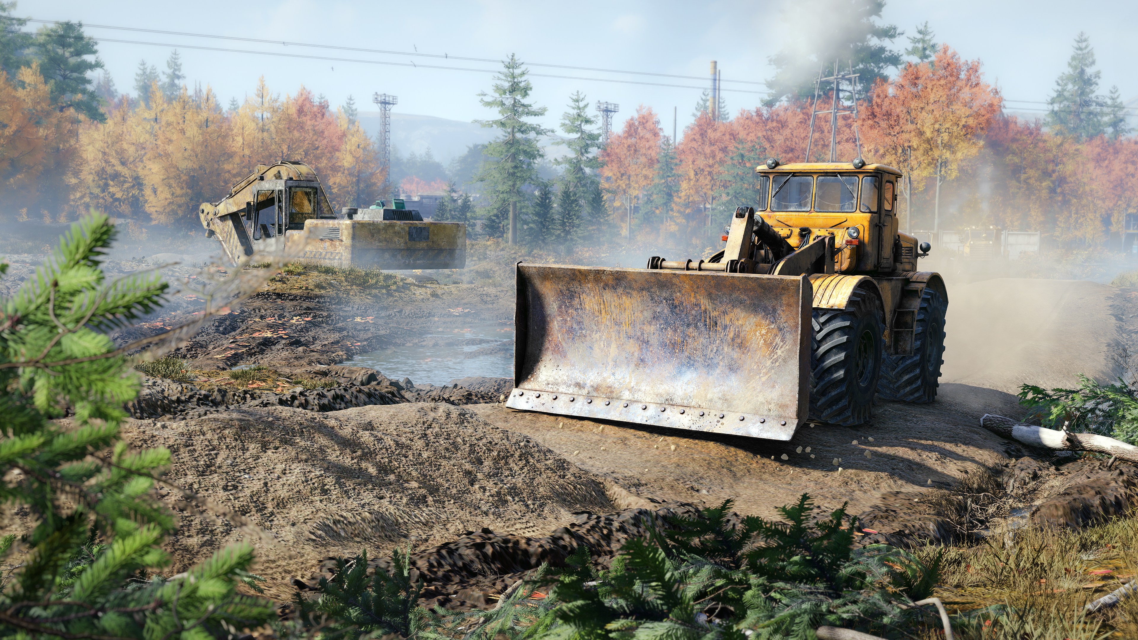 Gelber Bulldozer und Bagger auf einer Baustelle, mit Bäumen im Hintergrund.