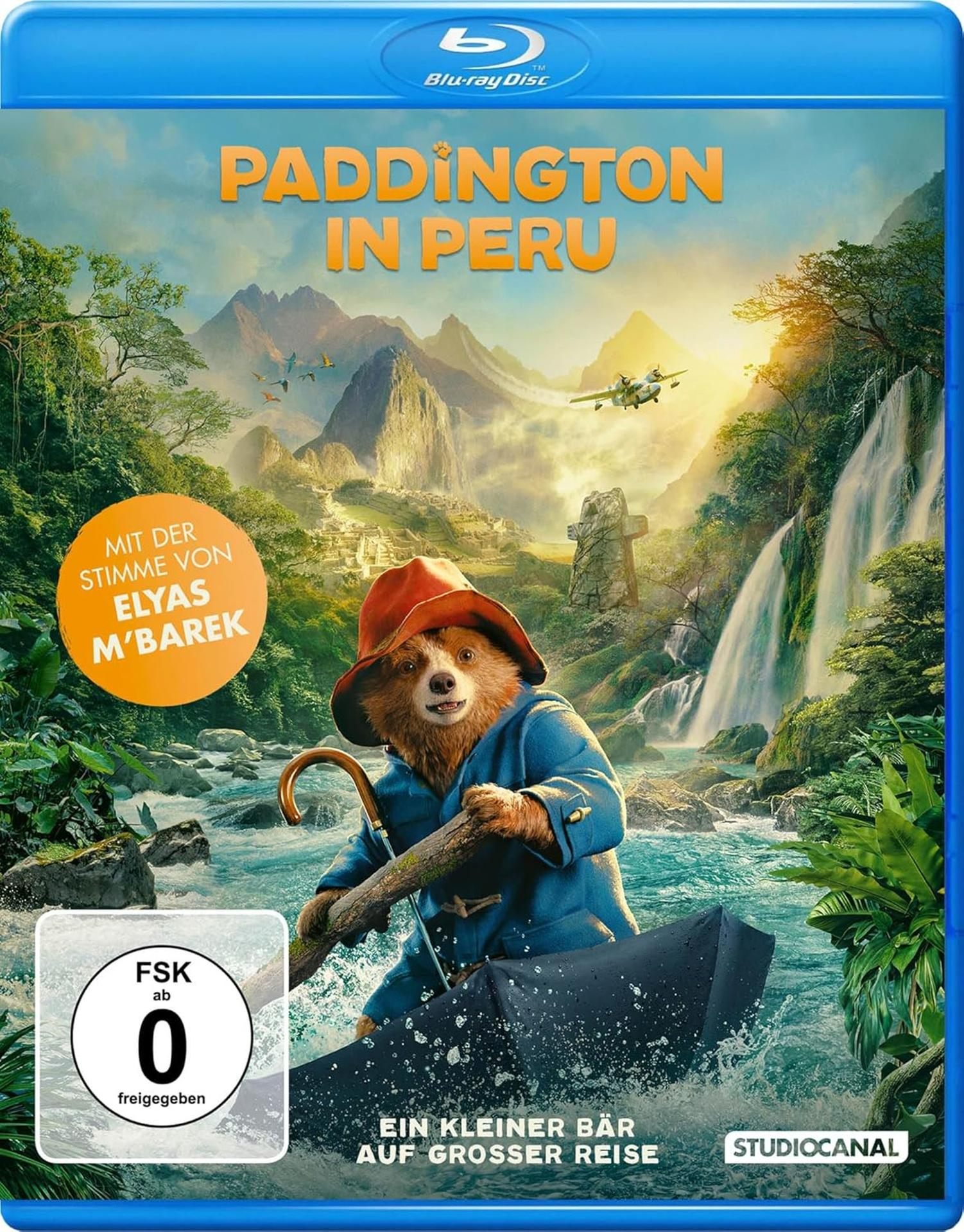 Blu-ray-Cover: Paddington in Peru. Bär im Boot, Wasserfall, Berge. Blaue und grüne Szene.