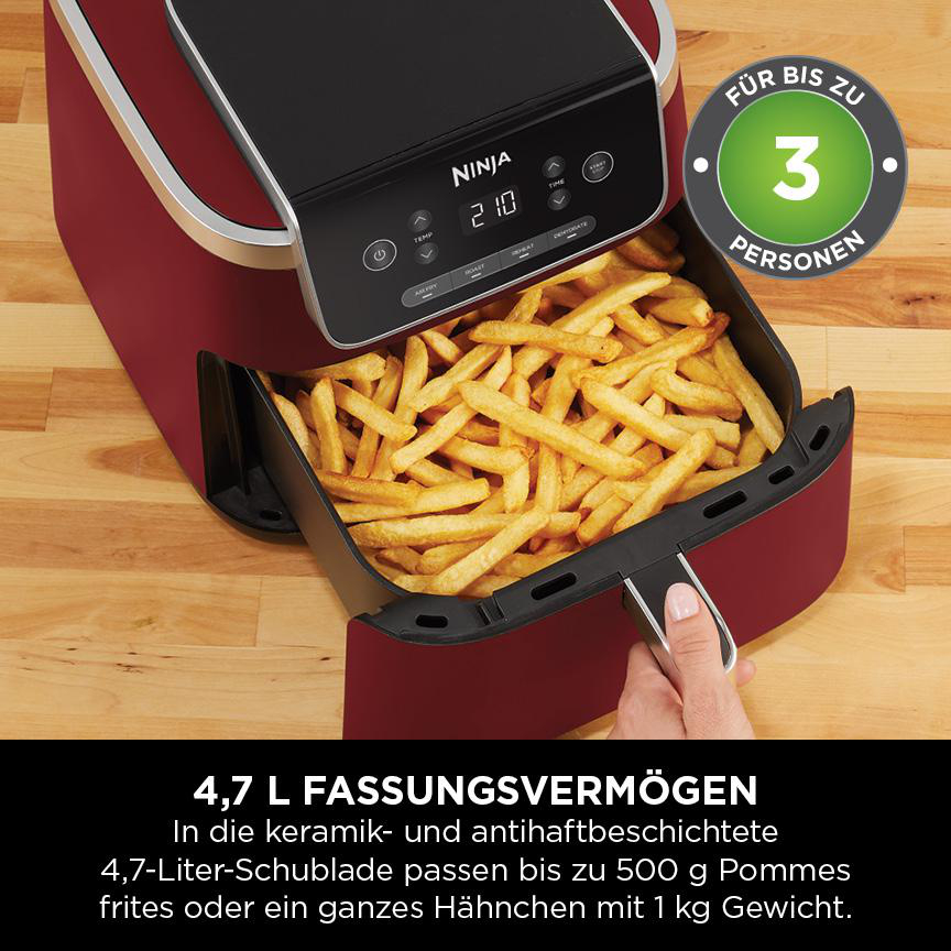 Roter Heißluftfritteuse mit Pommes Frites im Korb. Text enthält Kapazität und Funktionen.