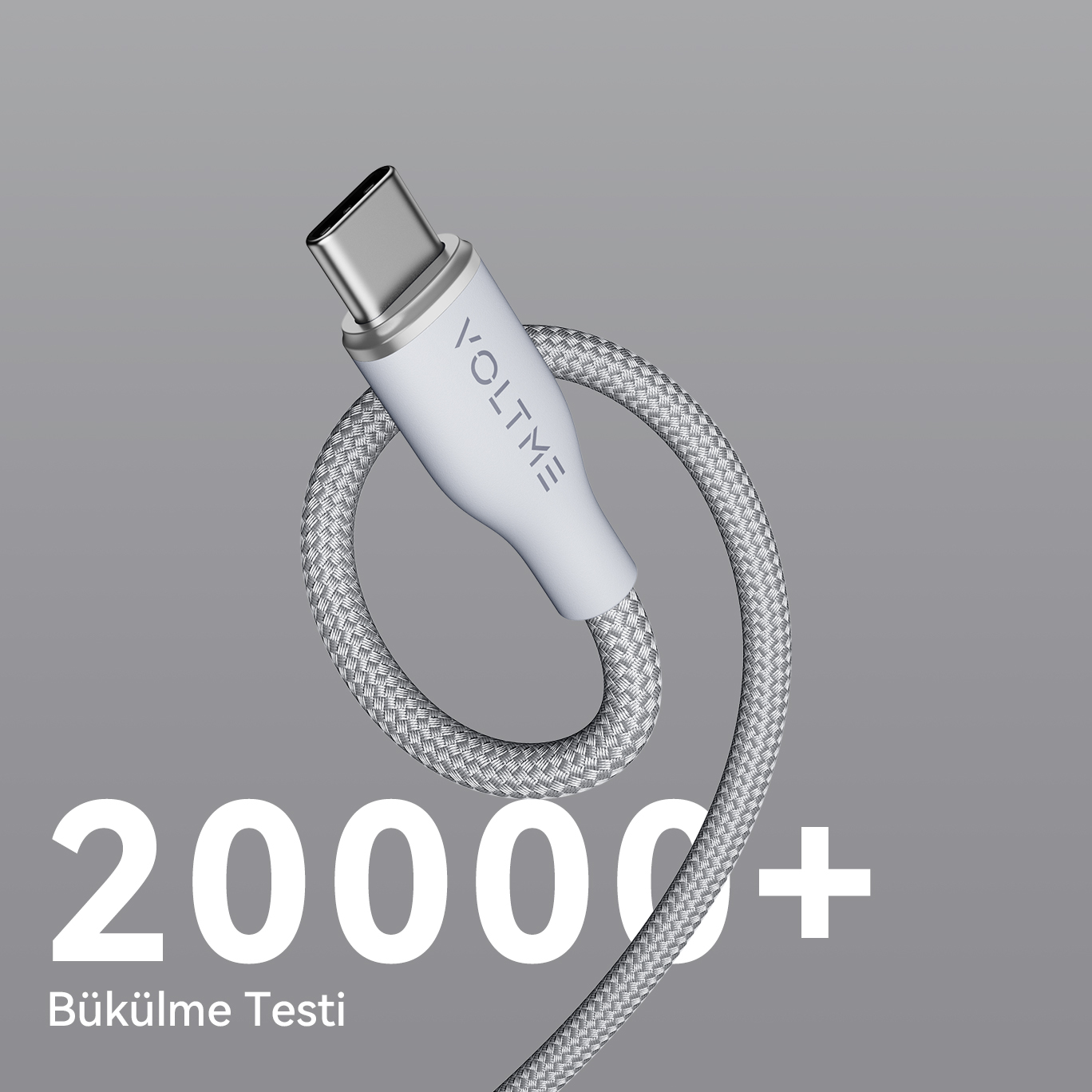 Beyaz konektörlü ve 'VOLTME' yazılı gri, örgülü bir USB-C kablosu.